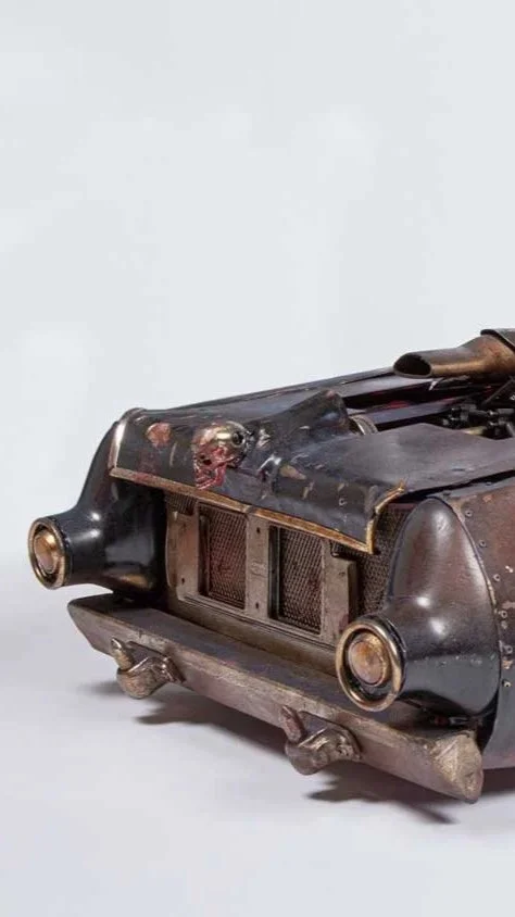Close-up of a worn and damaged vintage car grille with rust and scratches.