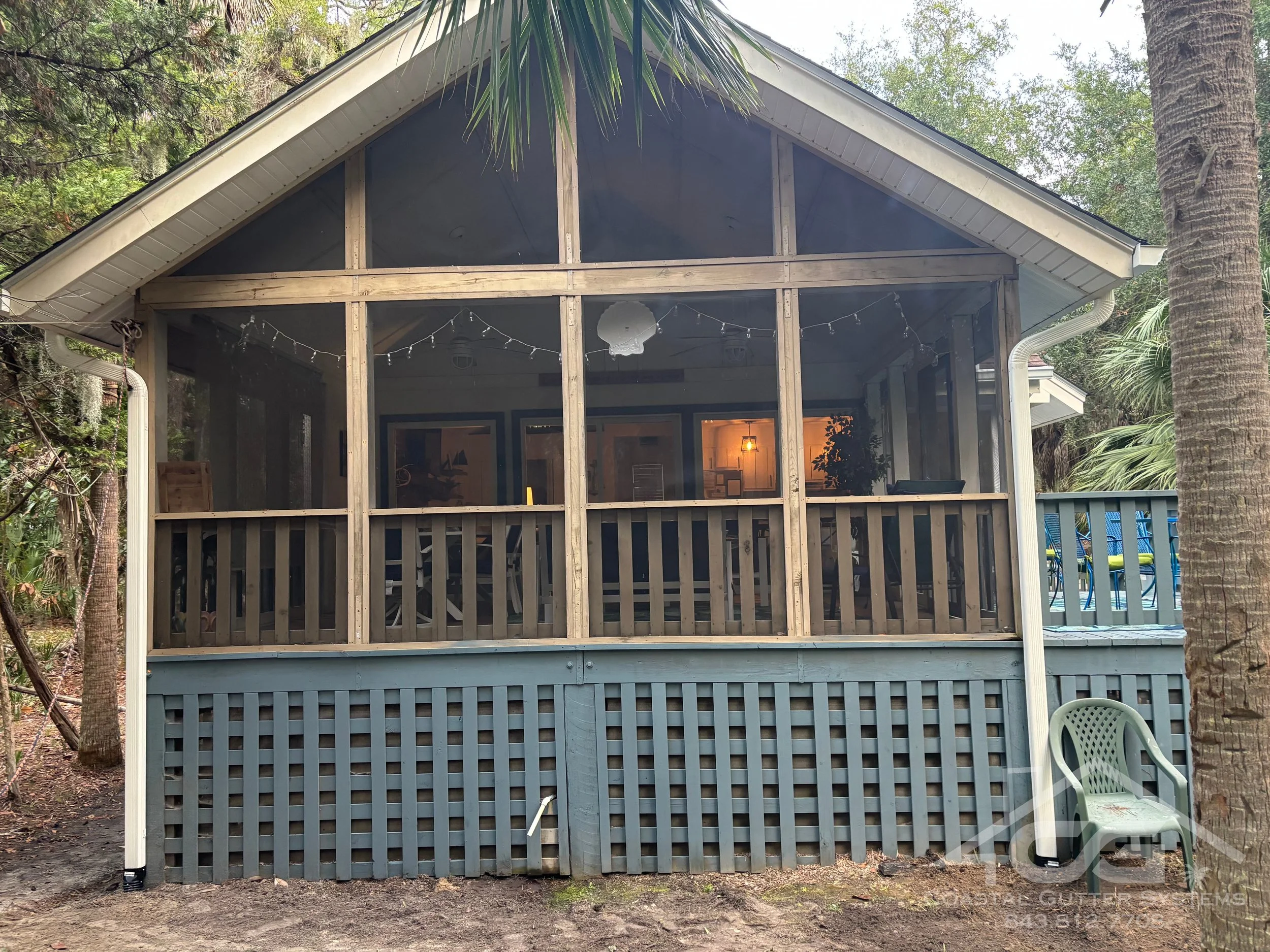 Professional seamless gutter installation with 6-inch K style Linen color gutters and downspouts on a screened porch home in Edisto, SC installed by Coastal Gutter Systems