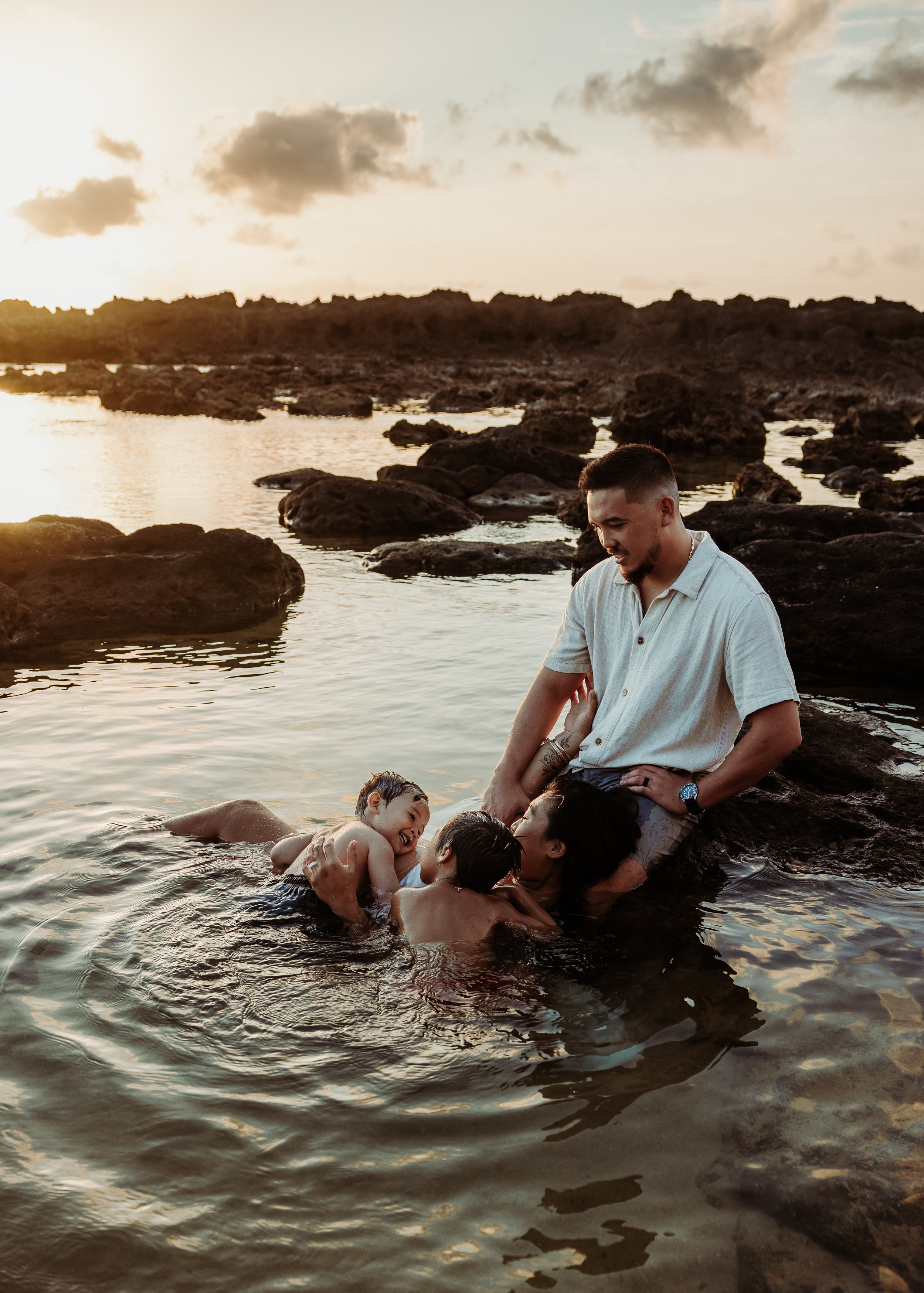 A family playing in the water at sunset on the North Shore of Oahu, Hawaii. | Wedding and Elopement Photography & Videography | Oahu, Kauai, Maui, Hawaii Island, Hawaii