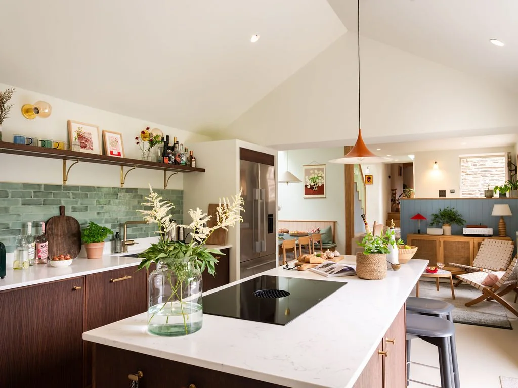 Kitchen and dining area with induction hob and fridge freezer at Lanvean Cottage