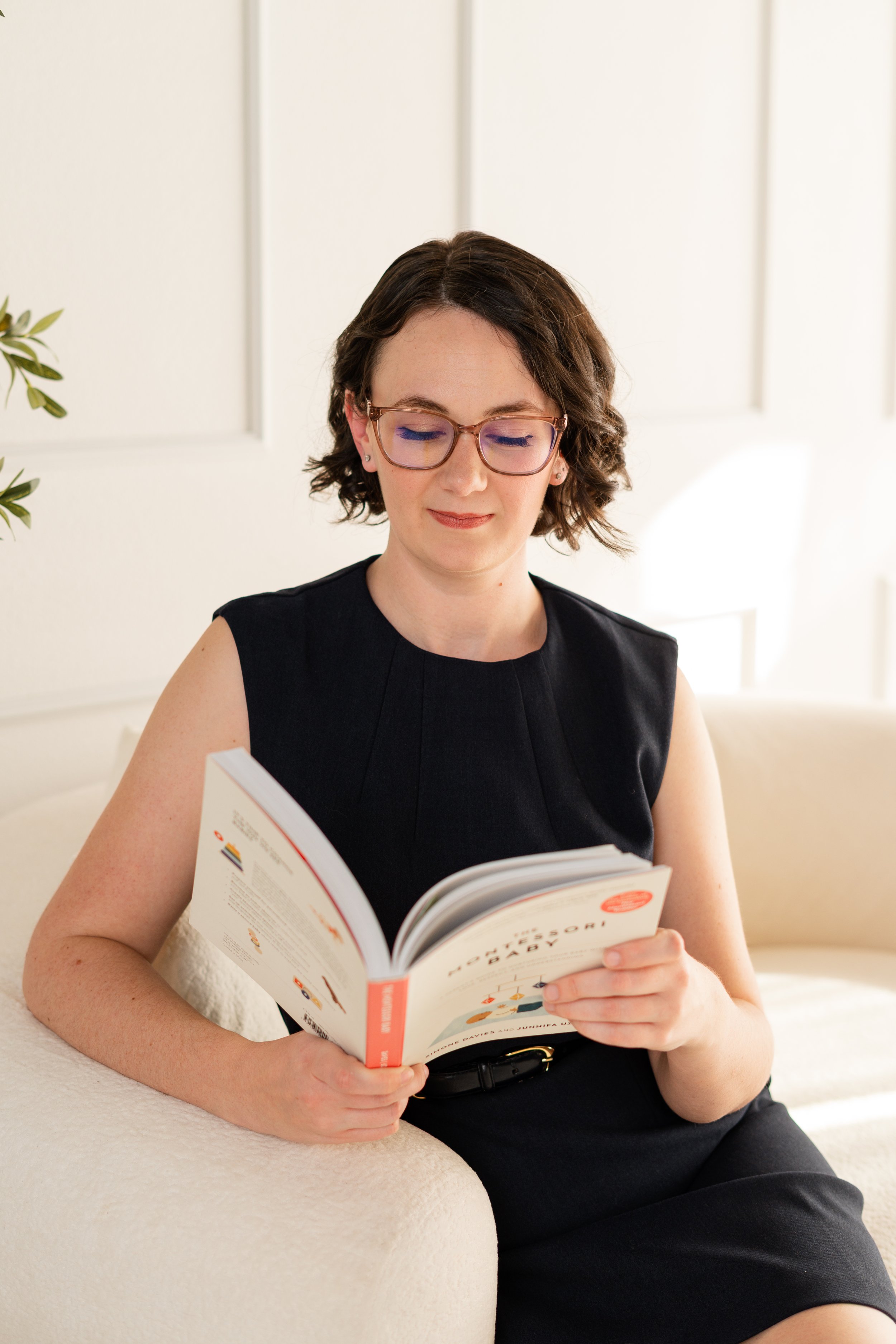 Jenna reading the Montessori Baby book to better support new parents as a postpartum doula.