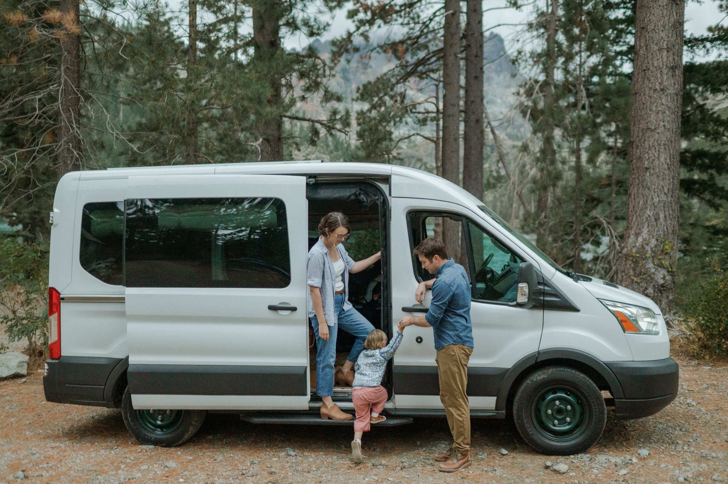 Jenna and her family with their campervan in the forest.