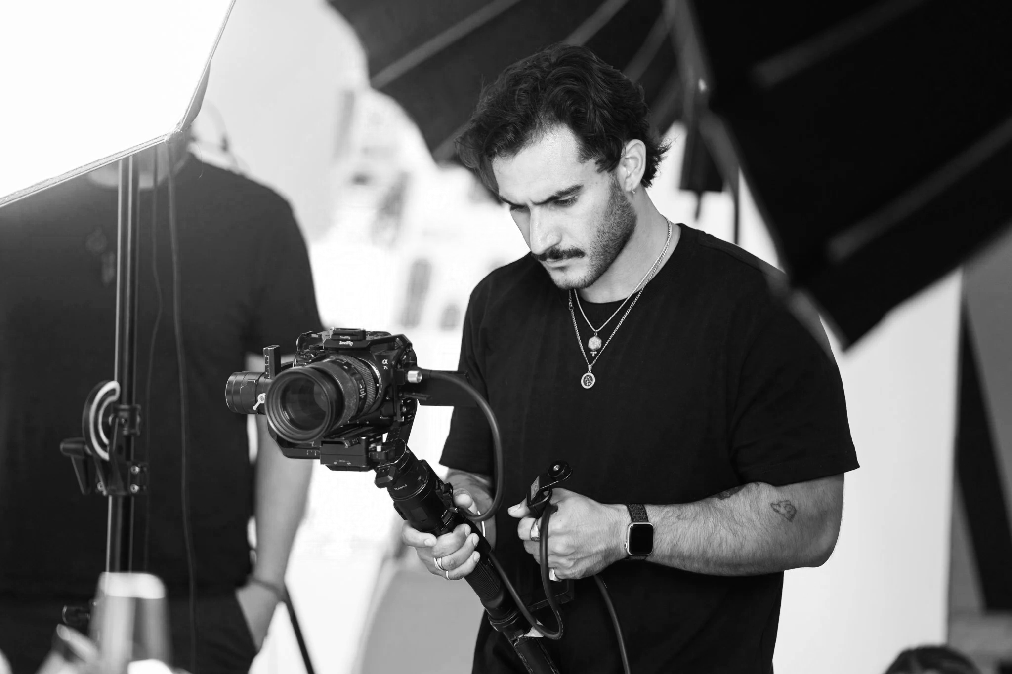 Drifter Media founder Riccardo Annandale on set during a brand content production shoot in Cape Town, operating a Sony mirrorless camera on a DJI gimbal stabiliser with professional studio lighting.