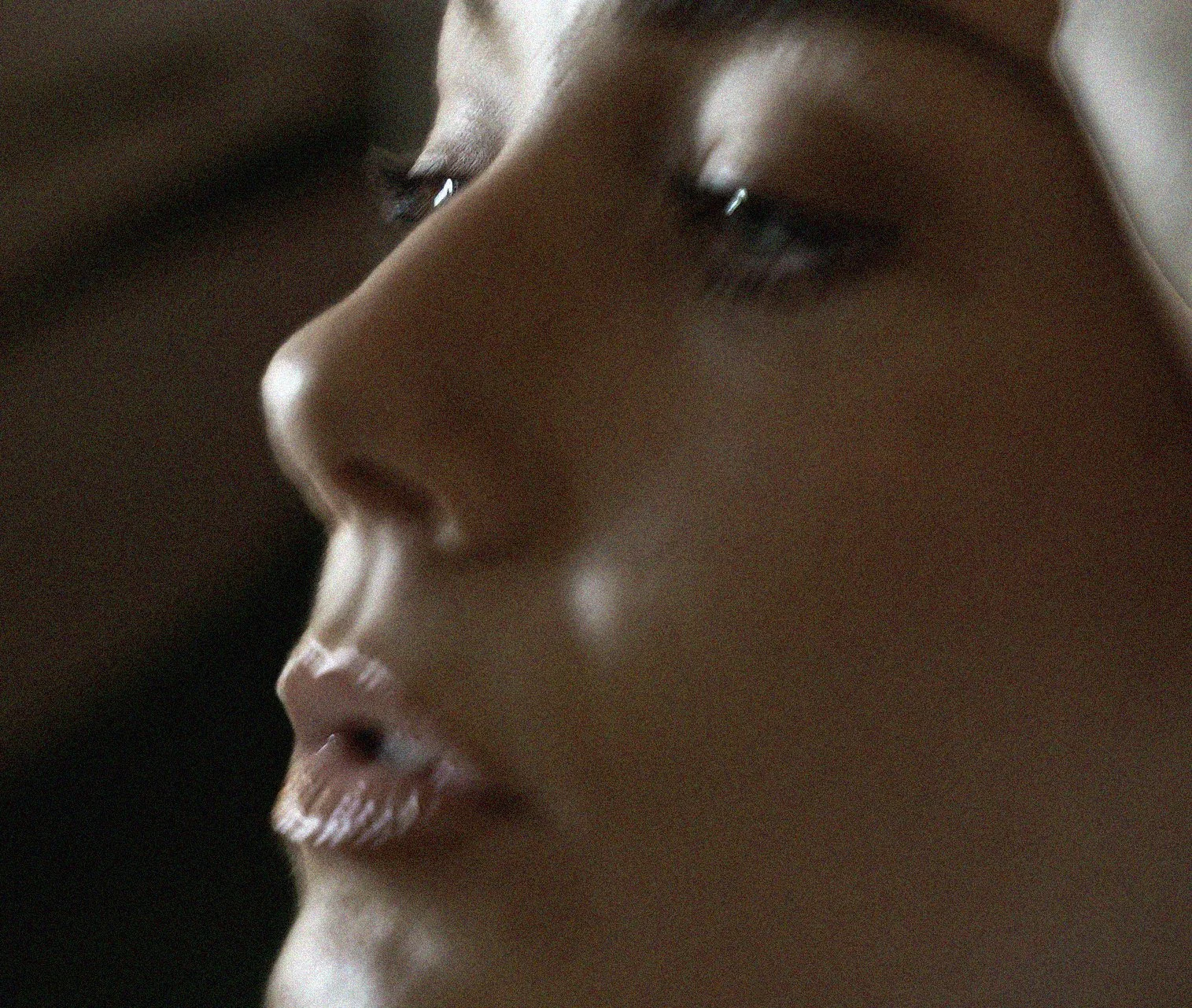 Brand campaign shoot for Melbourne small business Close-up profile of a person's face, showing forehead, nose, lips, and chin, with the person appearing to be in a calm or contemplative state.