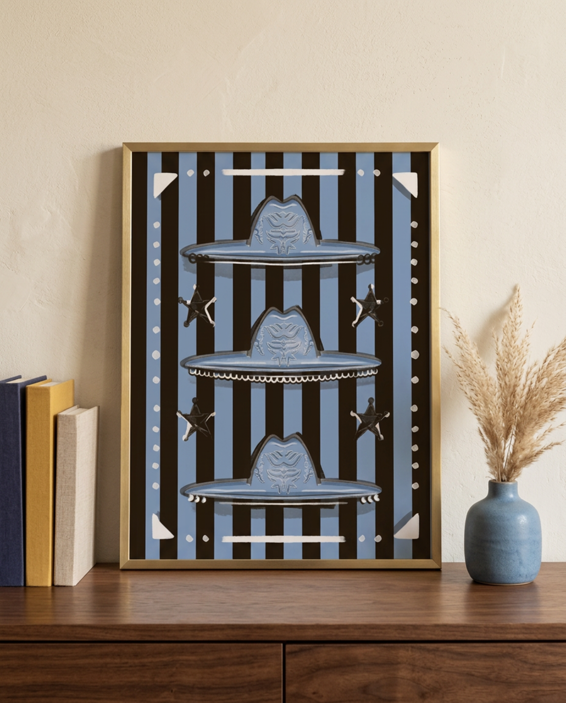 Three blue cowboy hats with sheriff stars on black and blue stripes, framed on a wooden dresser