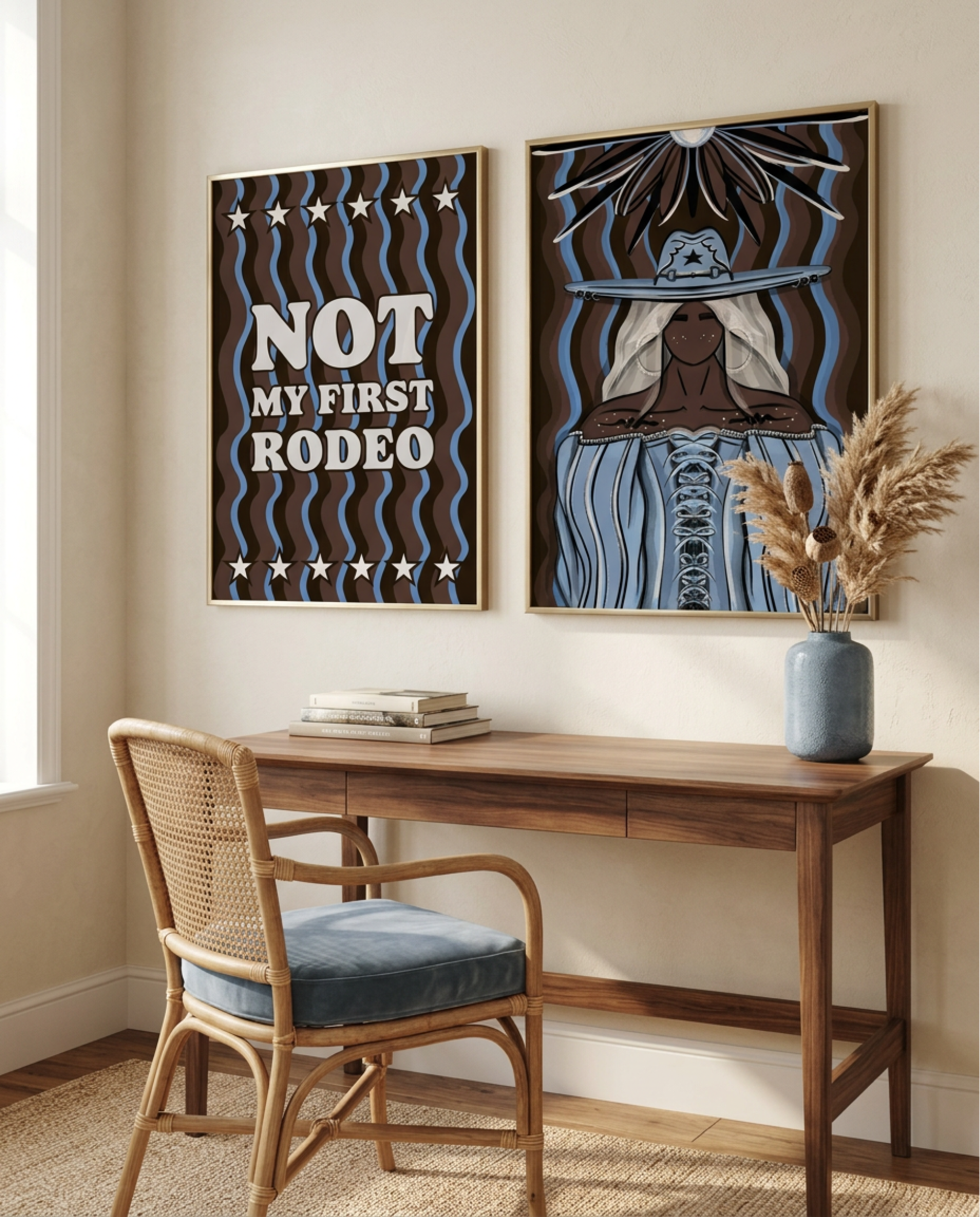 Not My First Rodeo print and western cowgirl portrait print framed above a wooden desk and rattan chair