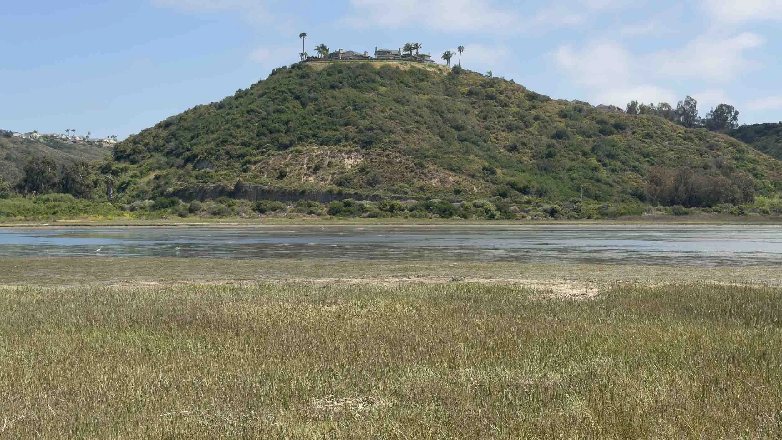 I believe that ridge is at the end of Amalfi Dr cul de sac in Encinitas. The photo was taken from the Northshore of Batiquitos Lagoon.