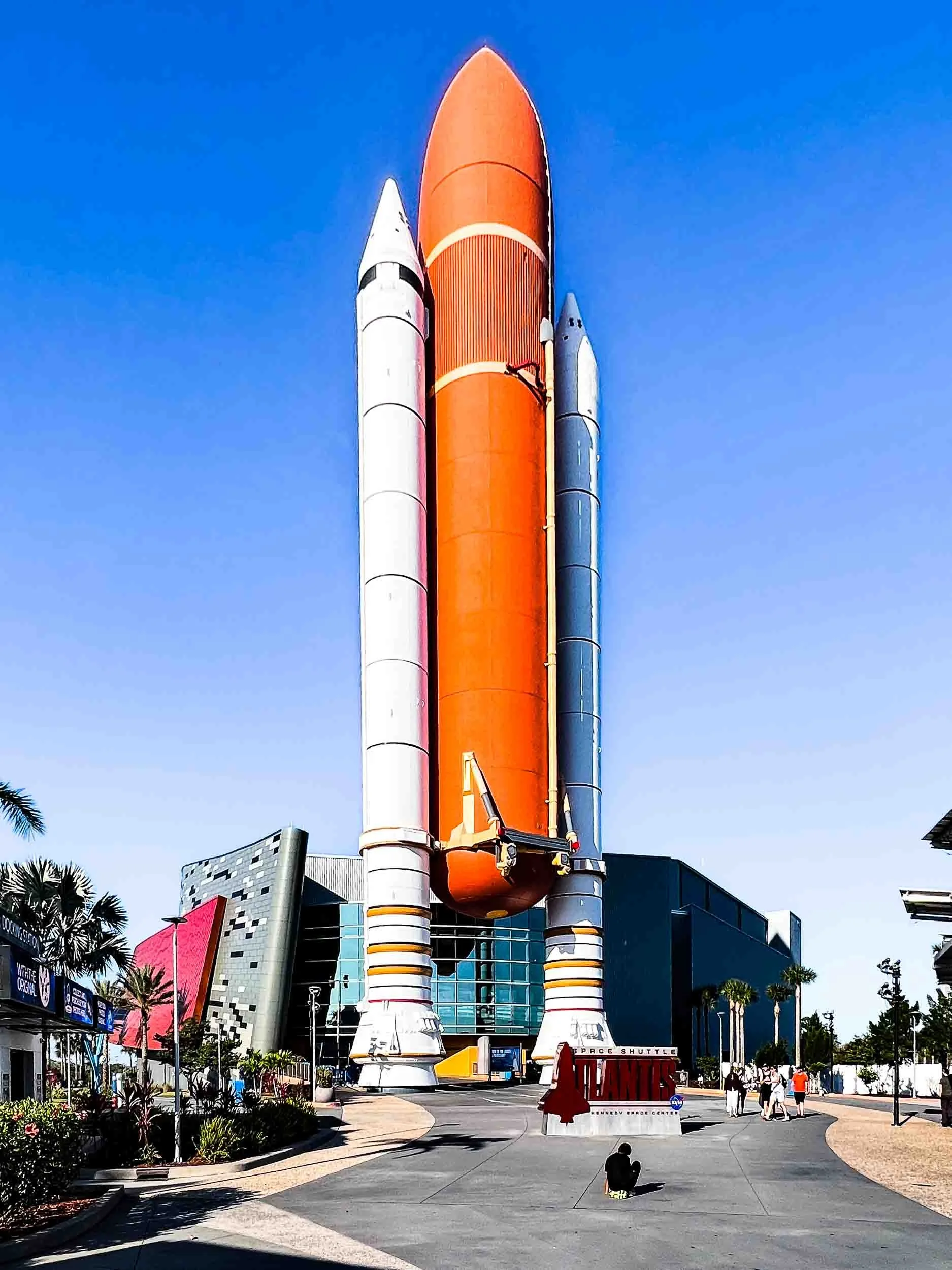 Full-scale replica of the External Tank and the Solid Rocket Boosters for the Space Shuttle Atlantis. This display is at the entrance to the exhibit building, visible in the background.