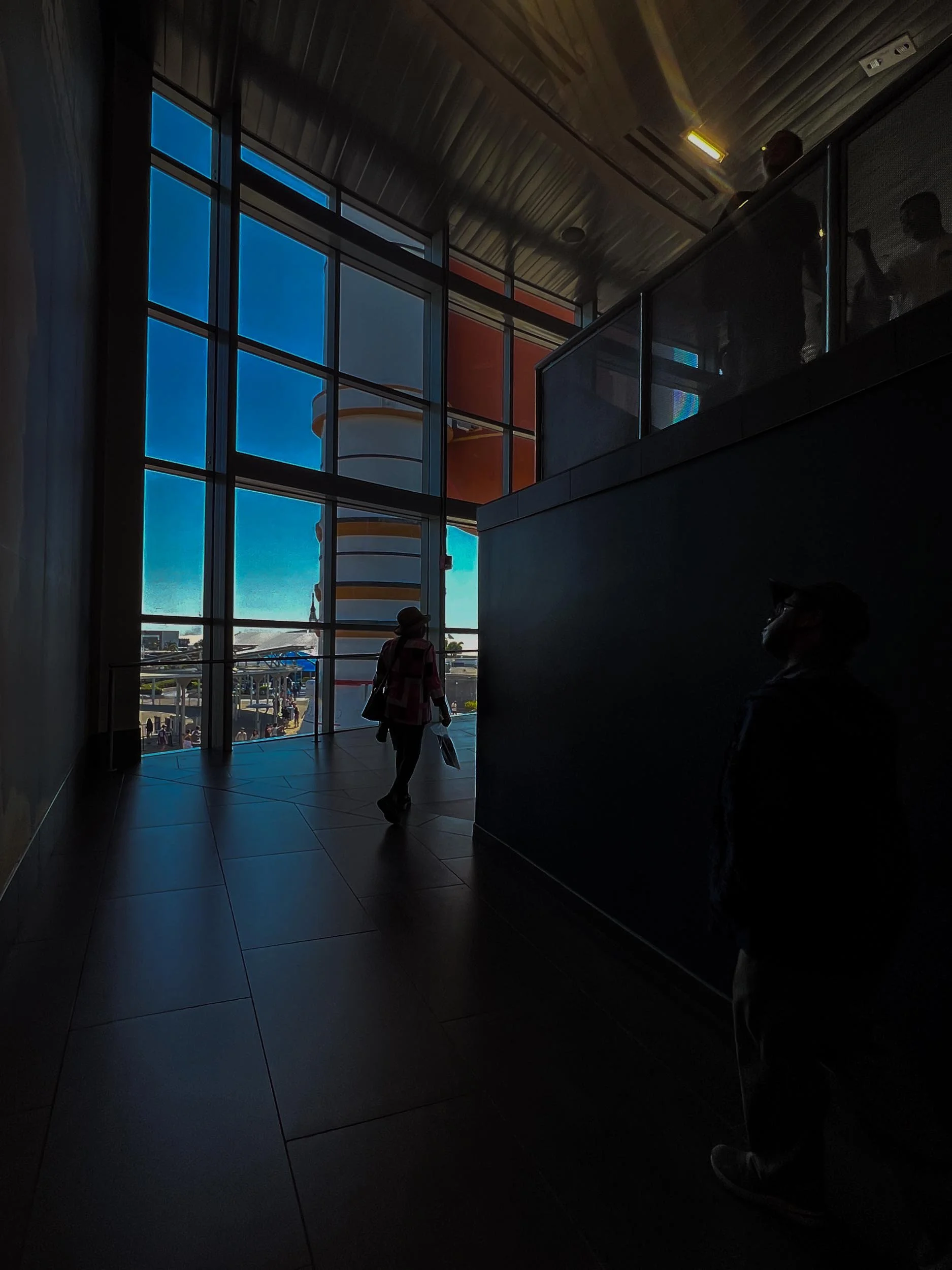 Notice a partial glimpse of the Space Shuttle Atlantis External Tank and Rocket Booster replica through the glass windows.
