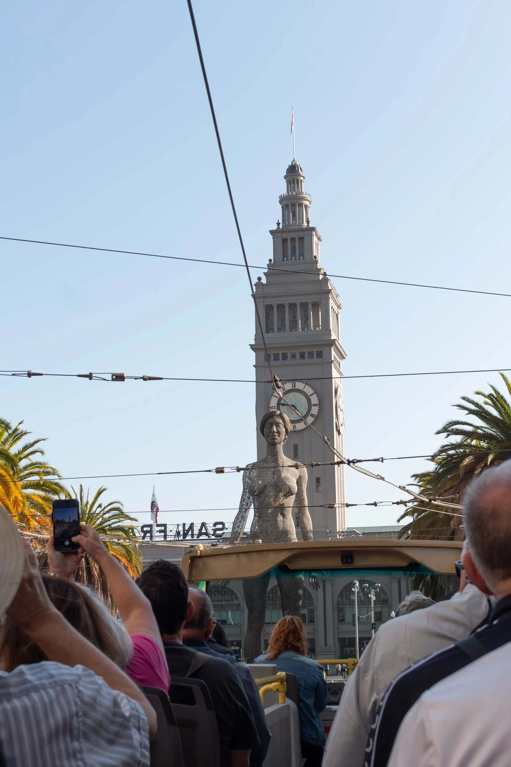 R-Evolution, 45-foot tall steel mesh statute located in Embarcadero Plaza in San Francisco. Behind it is the iconic clock tower of the San Francisco Ferry Building. 