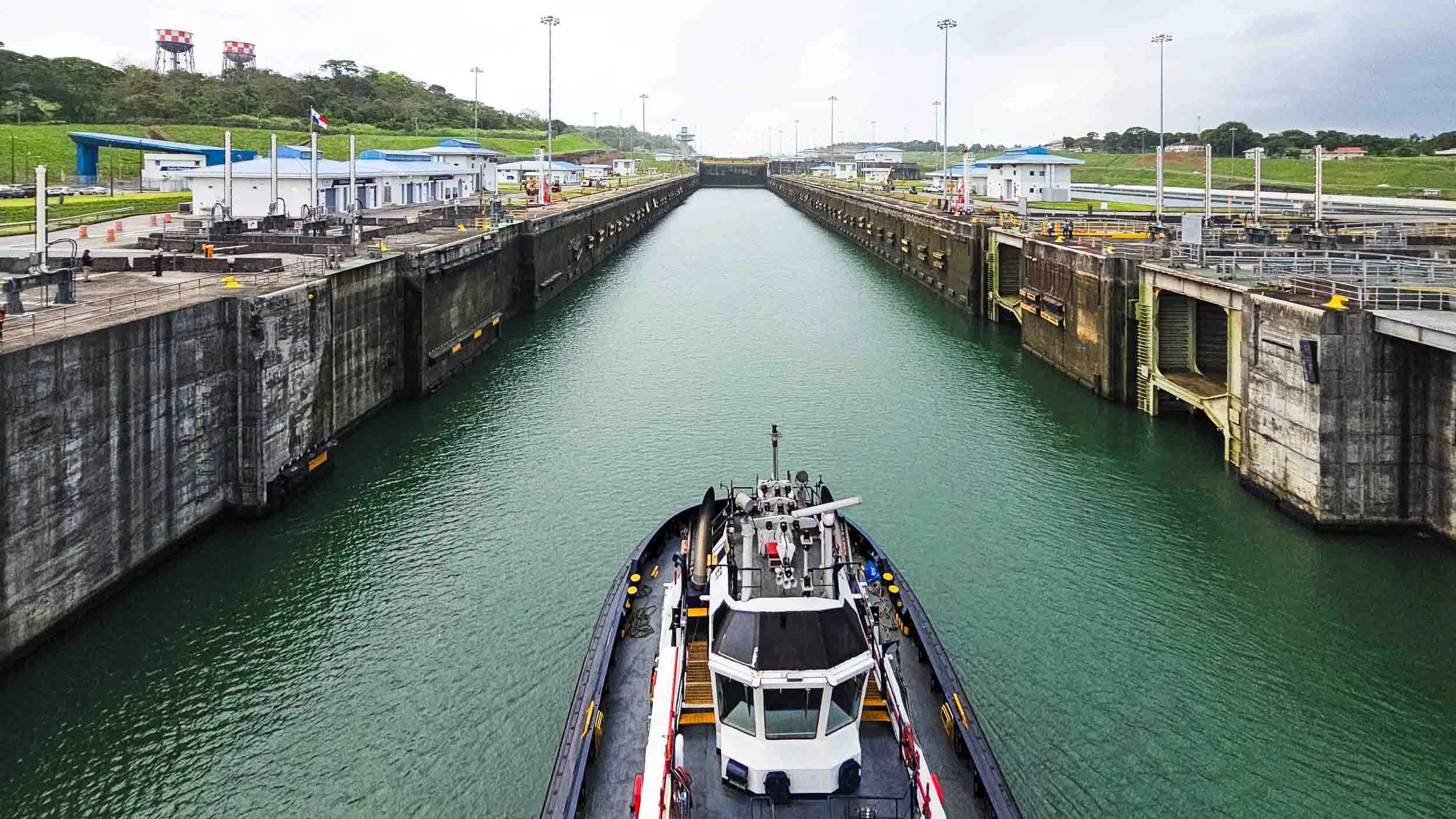 A guide boat leading the Caribbean Princess through the locks.
