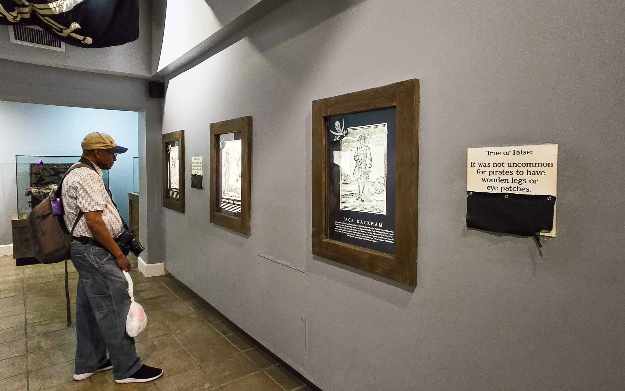 Looking at some exhibits on the wall inside the Pirates of Nassau Museum.