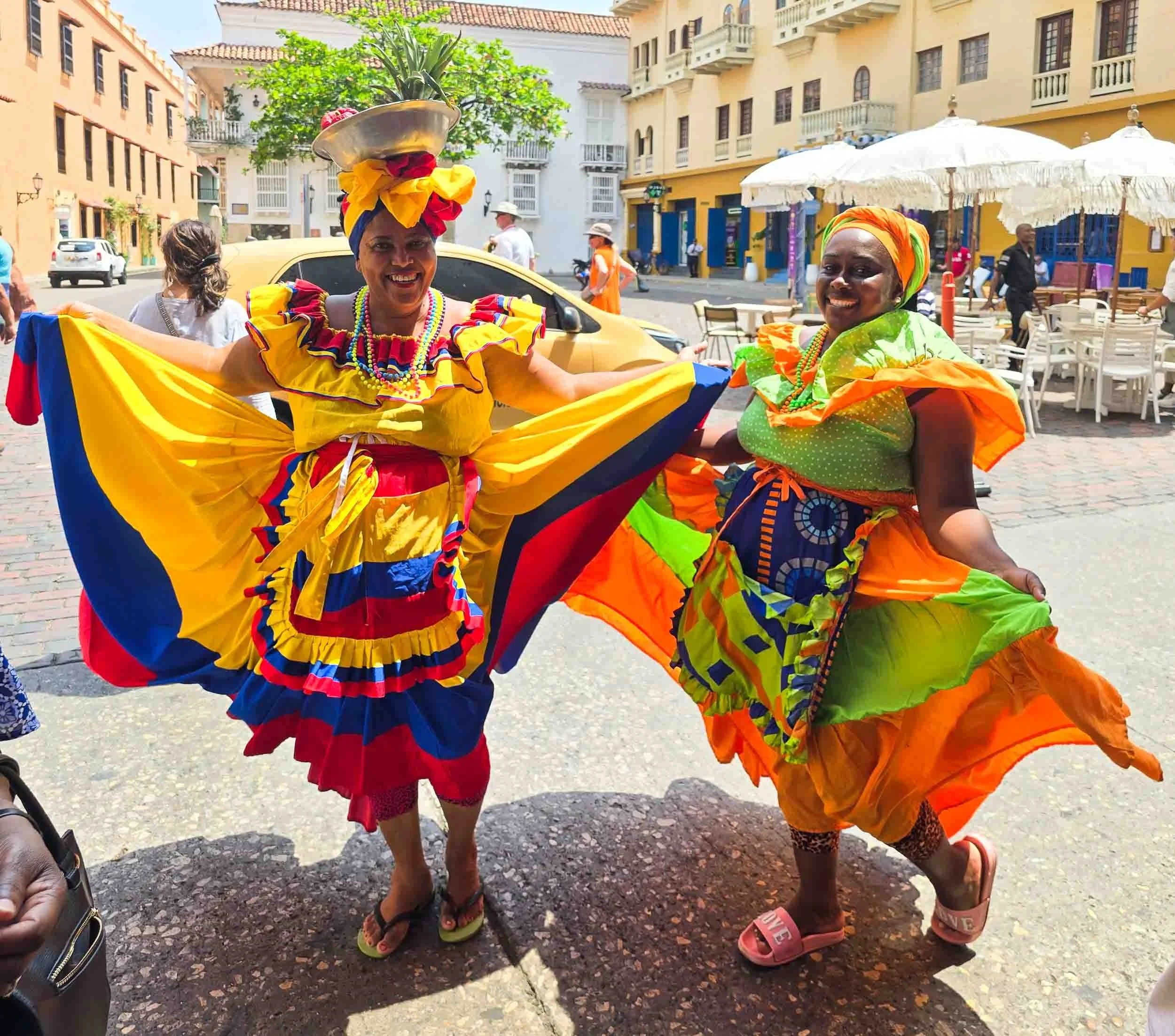 These beautifully costumed ladies use their charm to get tourist to take a photo and once that is done, then they request a payment for the opportunity. [kj]