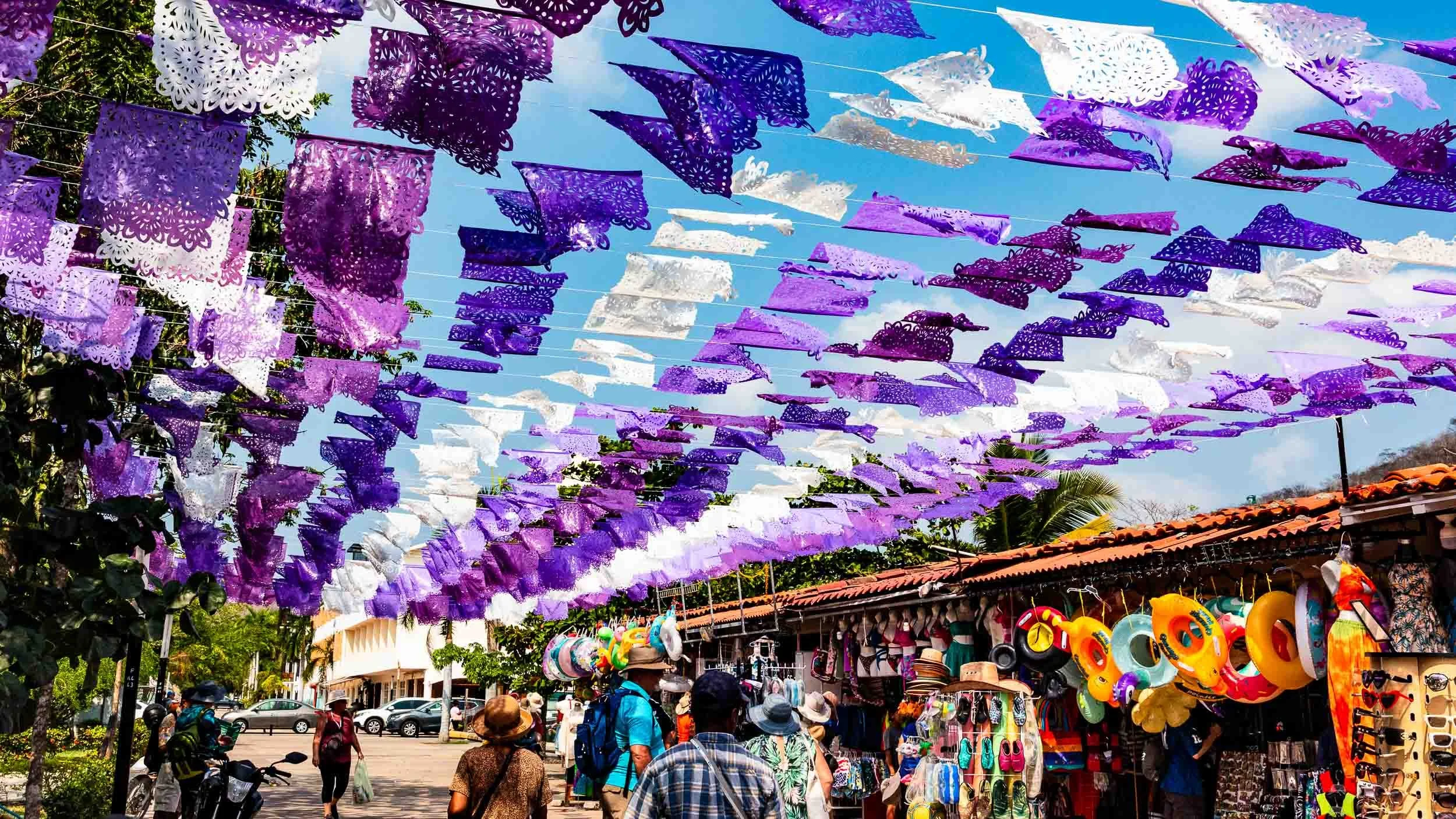 April 25, 2026: Papel Picado in Huatulco decorates the street but more importantly, via thermodynamics, they keep the street and anyone under them very cool.