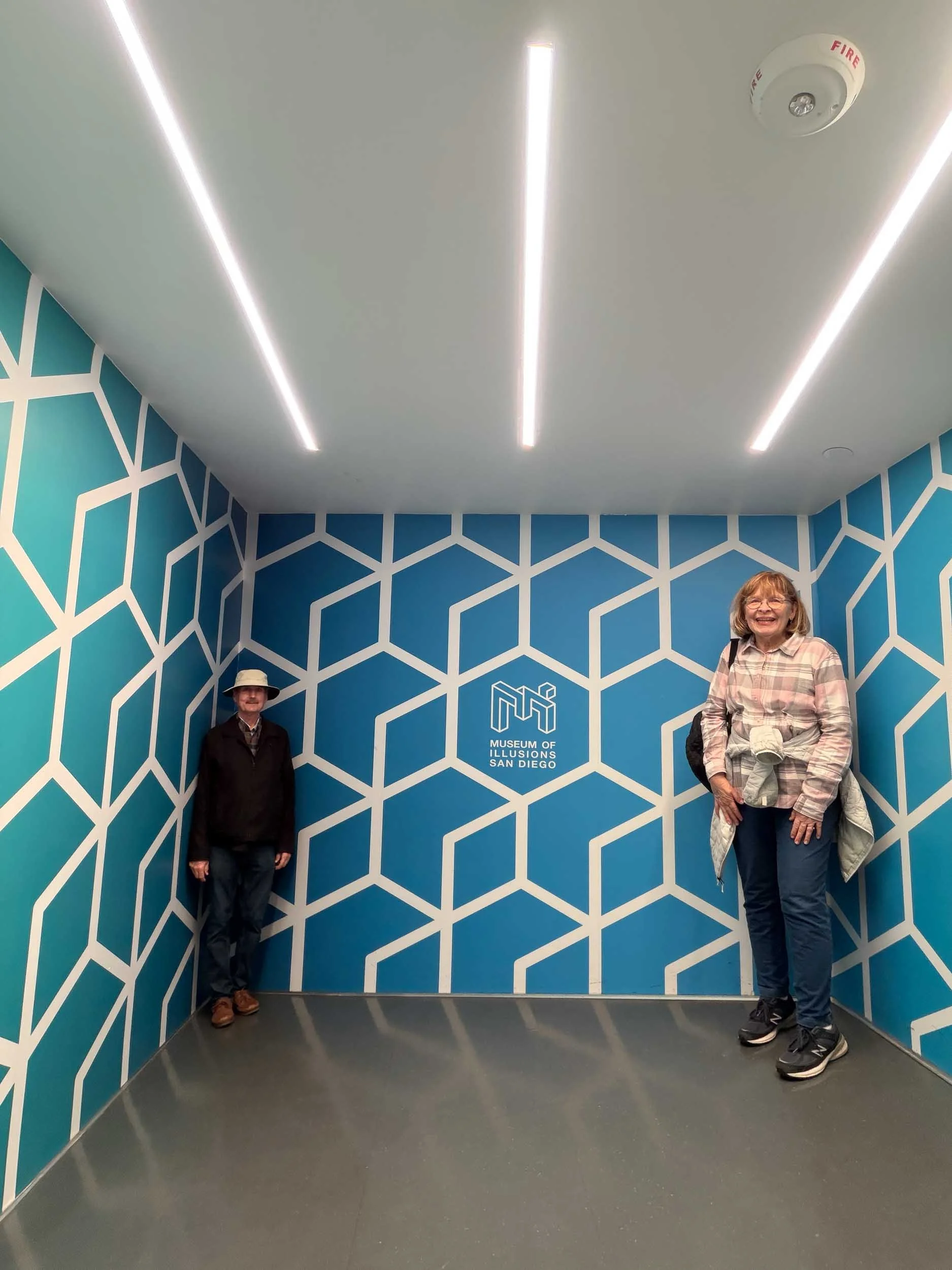 Inside the Museum of Illusion #7: The Ames Room. One person can appear as a giant compared to the other when two people stand in opposite corners of the same room.