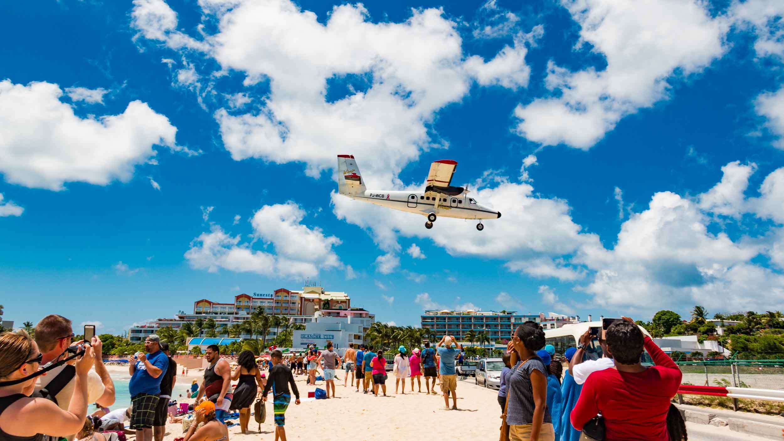 Princess Juliana International Airport, located on the Dutch side of the island of Sint Maarten. The plane is making final approach over Maho Beach, the world-famous location among aviation enthusiasts and tourists trying to be blown away by aircraft