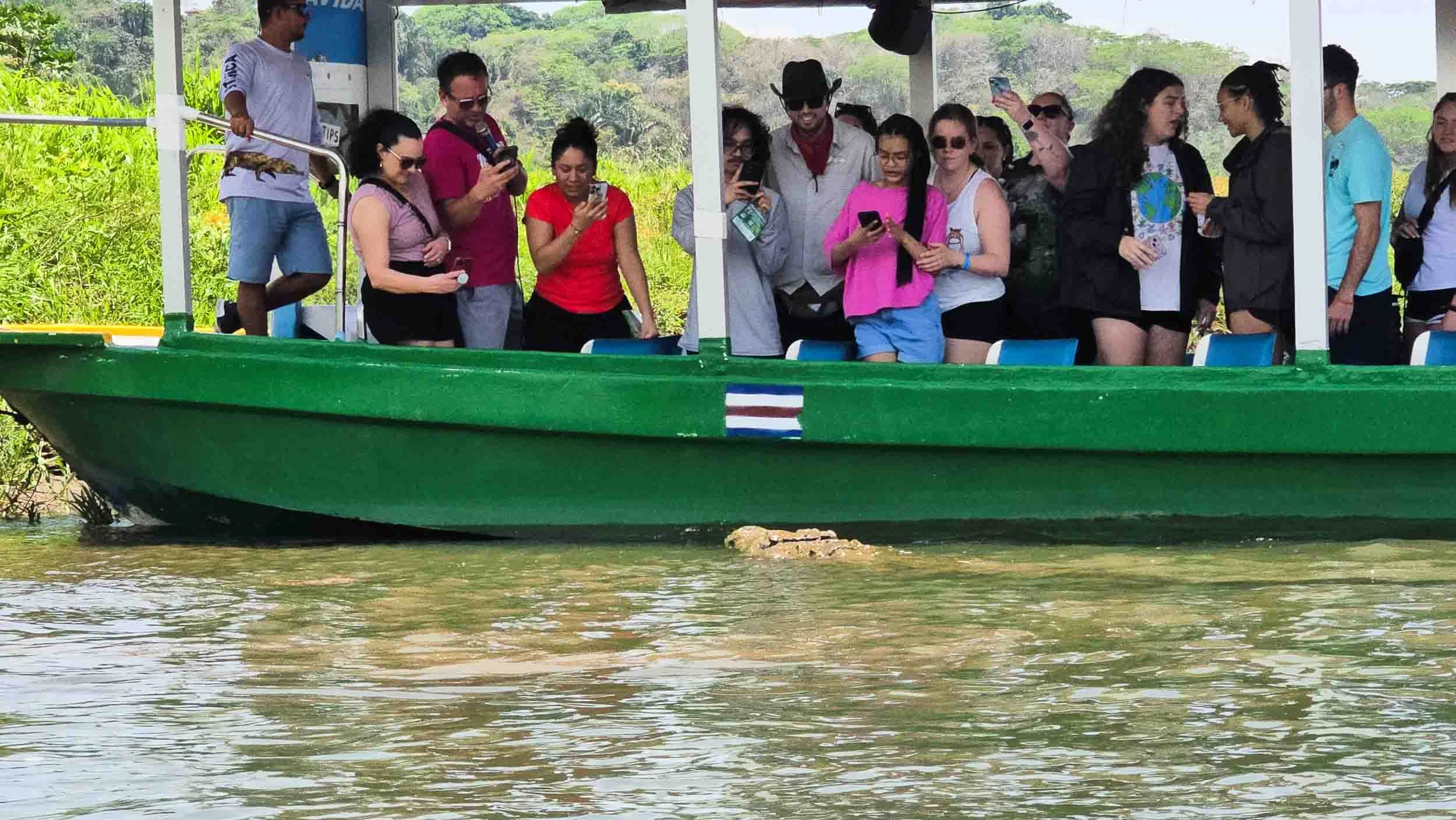 There is a crocodile getting a bit too close to this tour boat. We are in a similar boat at the back of him.