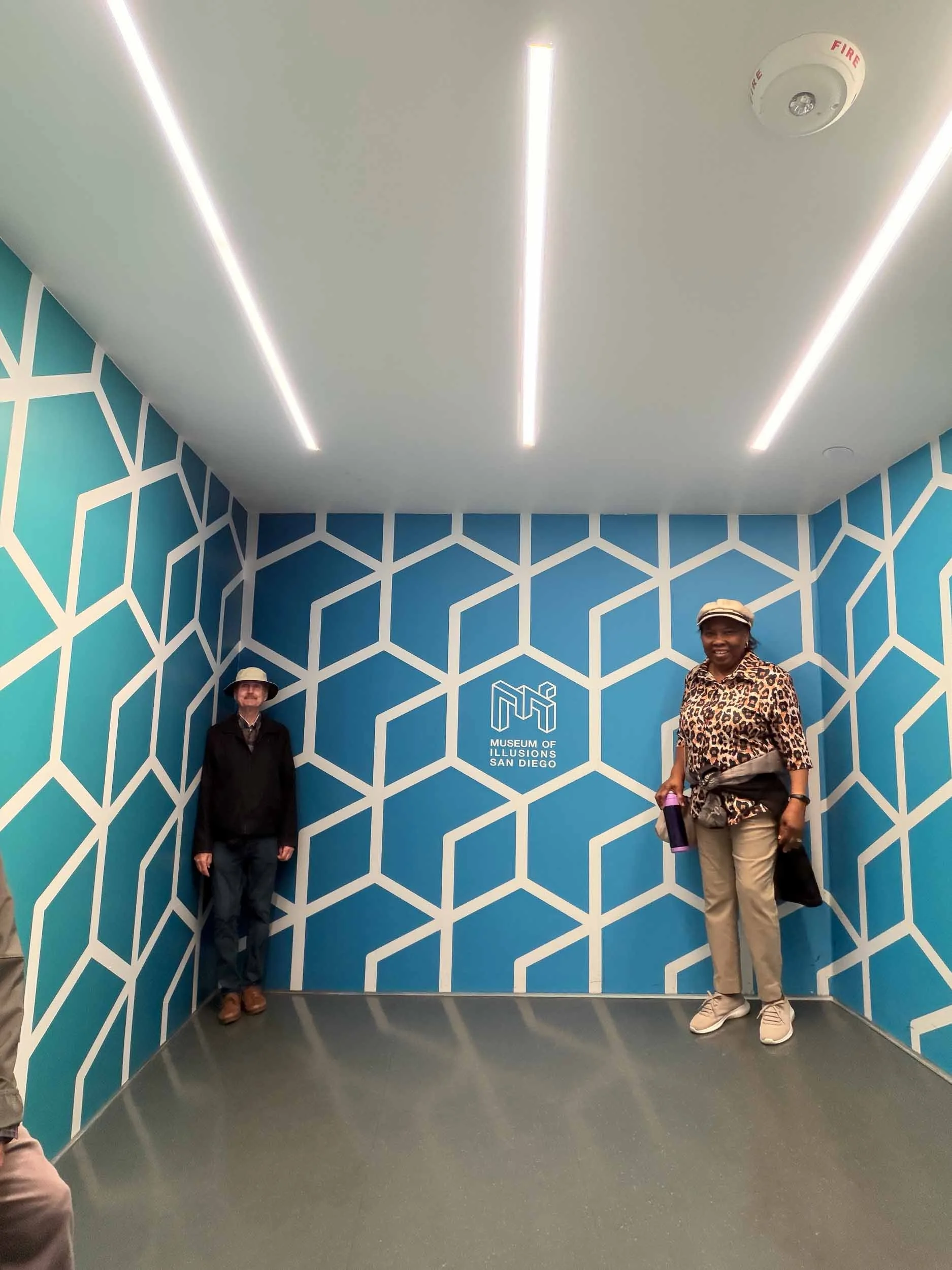 Inside the Museum of Illusion #6: The Ames Room. One person can appear as a giant compared to the other when two people stand in opposite corners of the same room.
