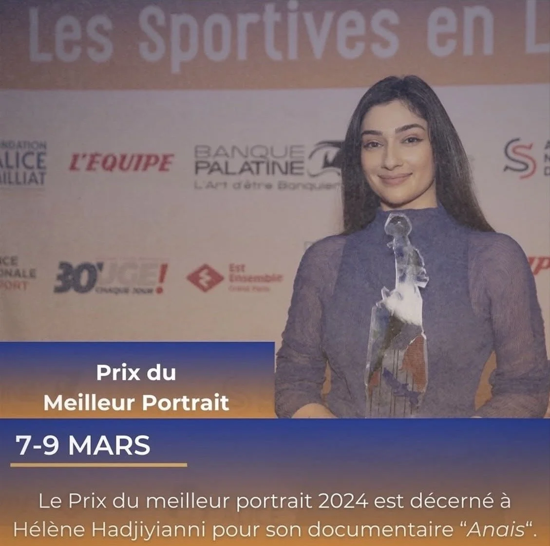 A young woman with dark hair holding a glass trophy, standing in front of a publicity backdrop with logos and text, celebrating receiving the 2024 Best Portrait Award for her documentary 'Anais', at an event from March 7-9.