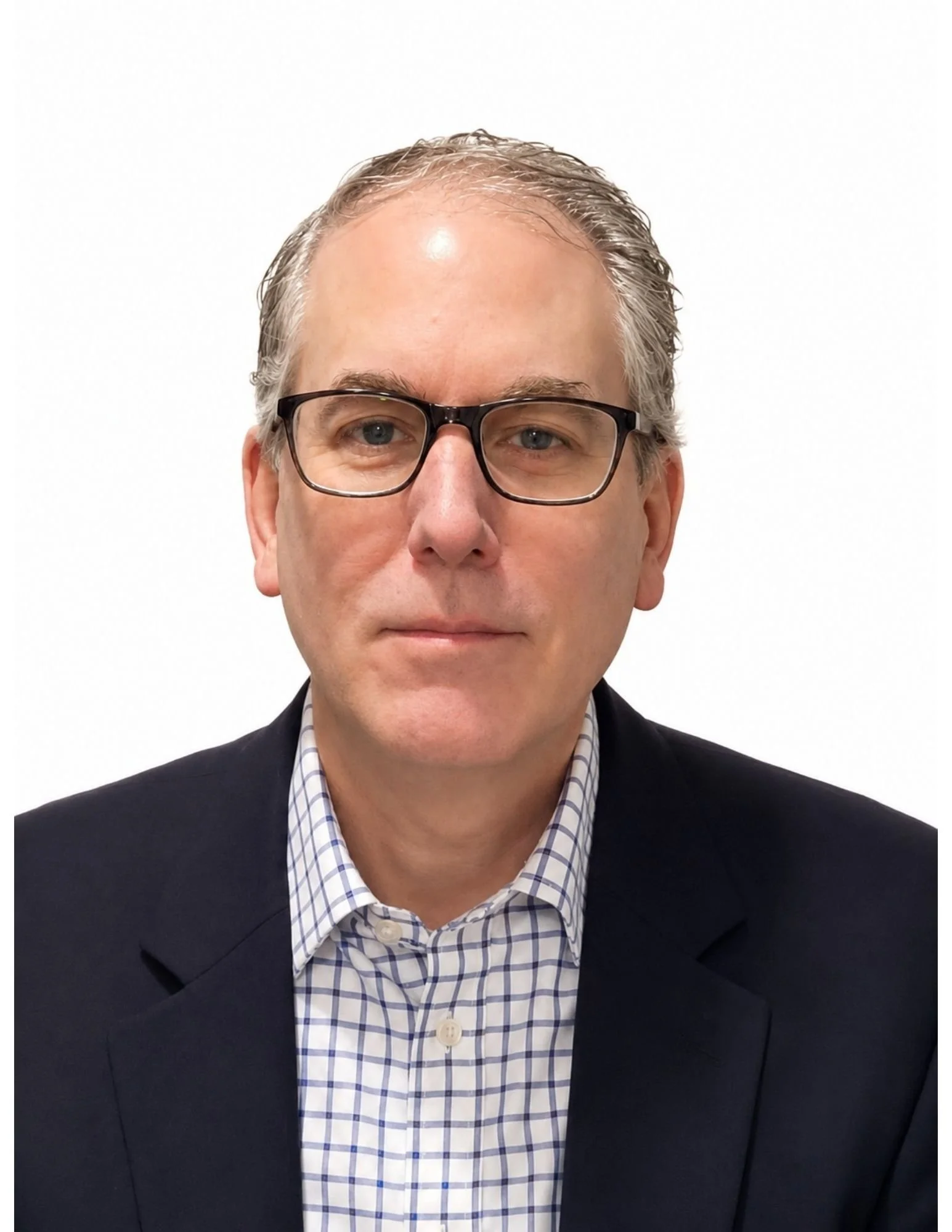 A man with gray hair and glasses wearing a checkered shirt and a dark blazer, posing against a white background.