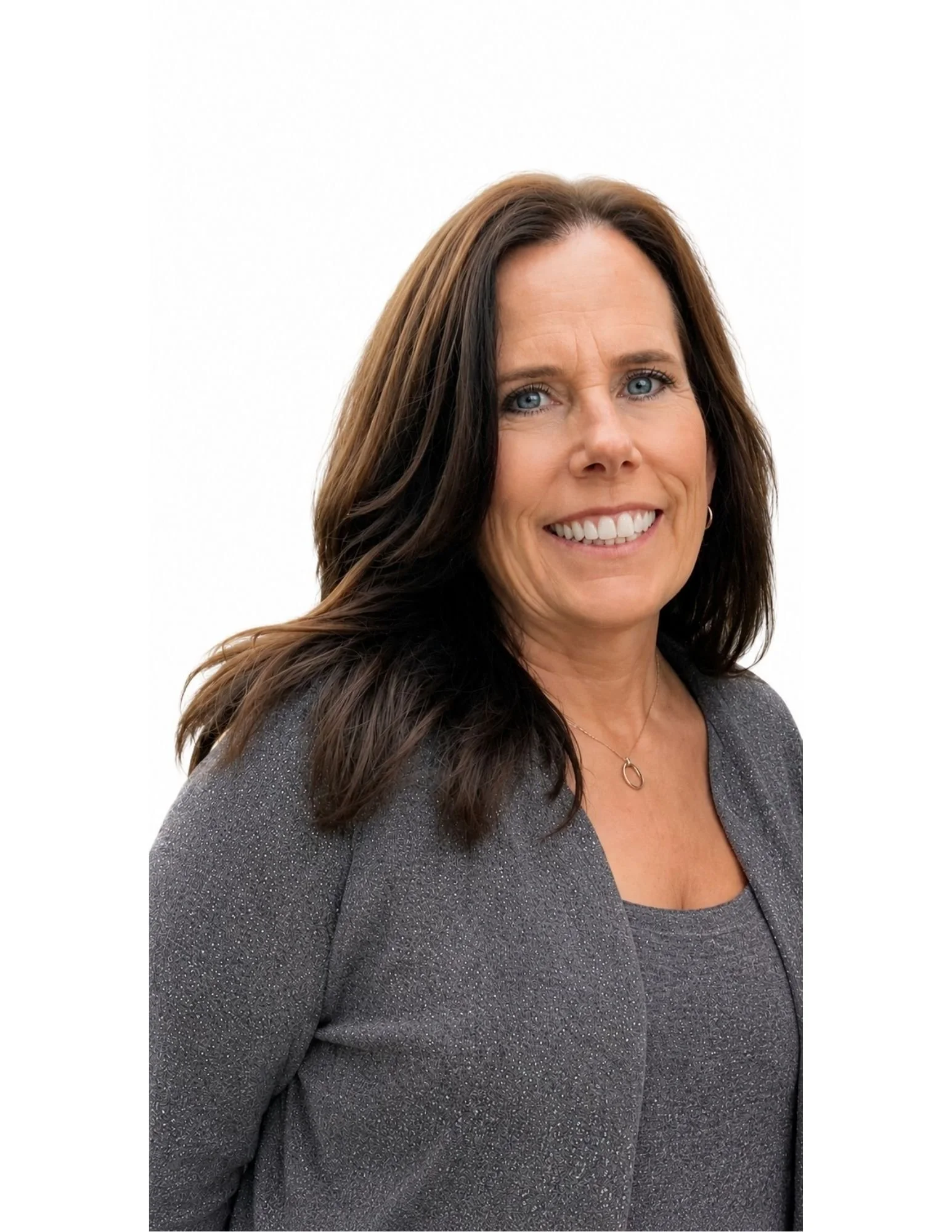 Close-up of a woman with long brown hair, blue eyes, and wearing a sparkly gray blazer, smiling against a plain white background.