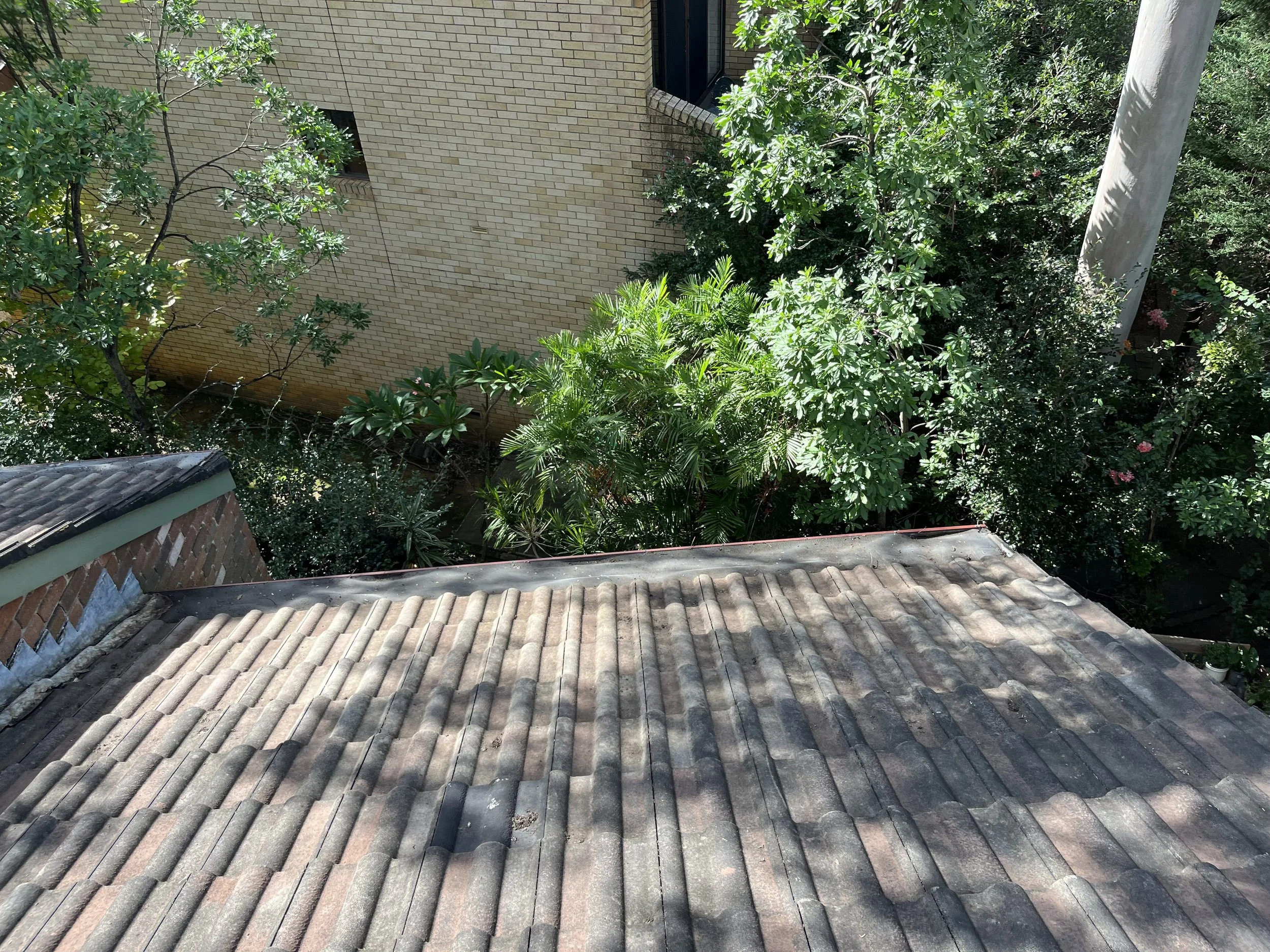 After gutter cleaning showing cleared gutters and improved water flow