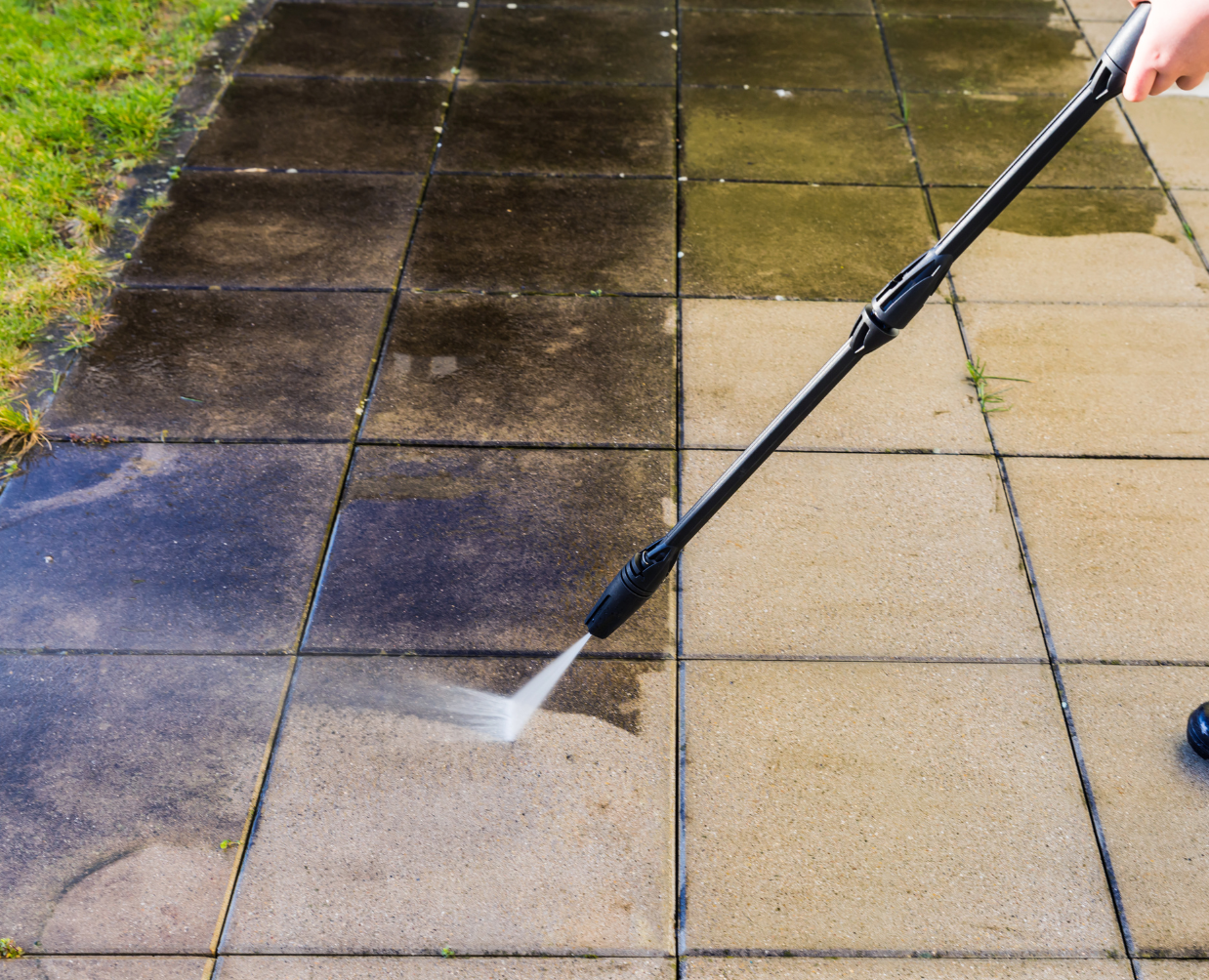 Pressure washing driveway in Sydney removing dirt and stains from concrete surface