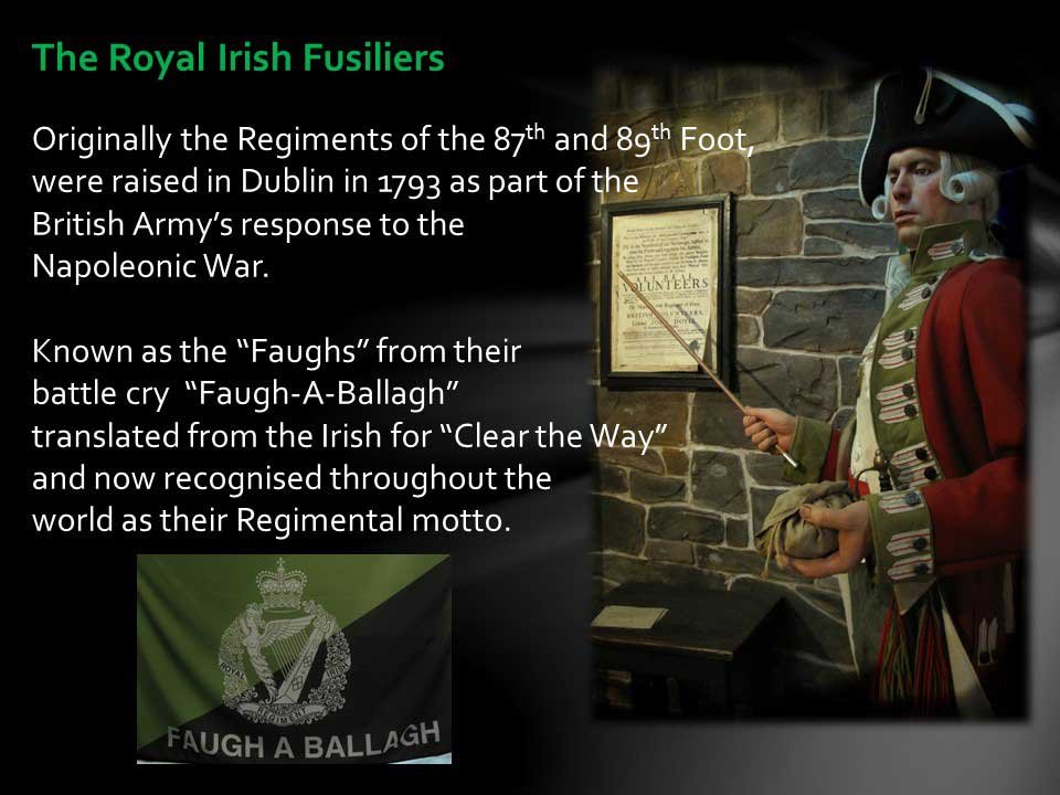Information panel about The Royal Irish Fusiliers, describing their history and motto, with a person dressed as a historical soldier in uniform, holding a pointer, standing next to a framed document on a stone wall, and a green flag with a crest and the phrase "Faugh A Ballagh" at the bottom.