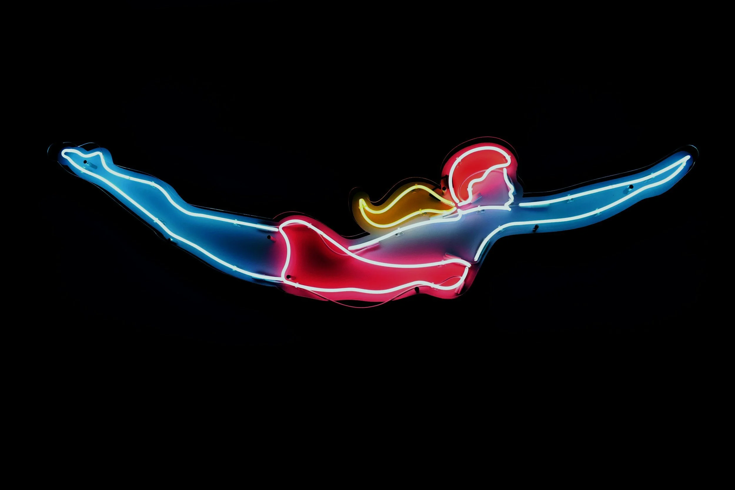 Neon sign of a woman in a swimsuit swimming with arms and legs extended