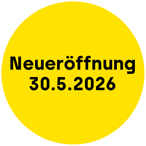 Gelbe Kreisscheibe mit schwarzer Schrift, ankündigend eine Neueröffnung am 30.05.2026.