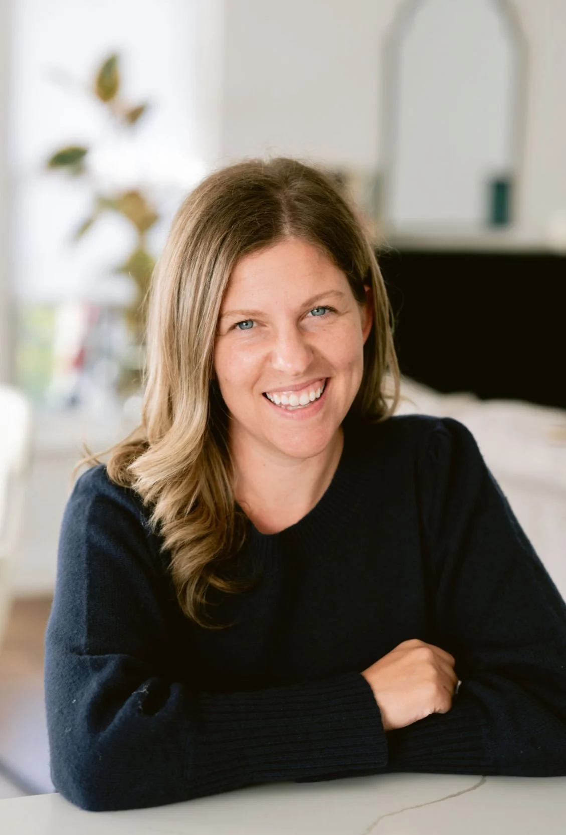 Nicole Karlis. black shirt, arms crossed and smiling