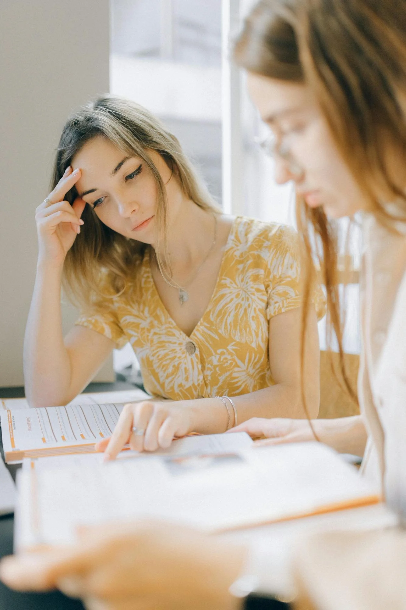 two women studying language books