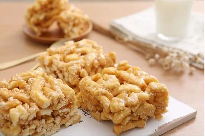 Close-up of peanut butter rice krispie treats on a white cutting board.