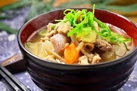 Bowl of Asian-style soup with vegetables and sliced green onions