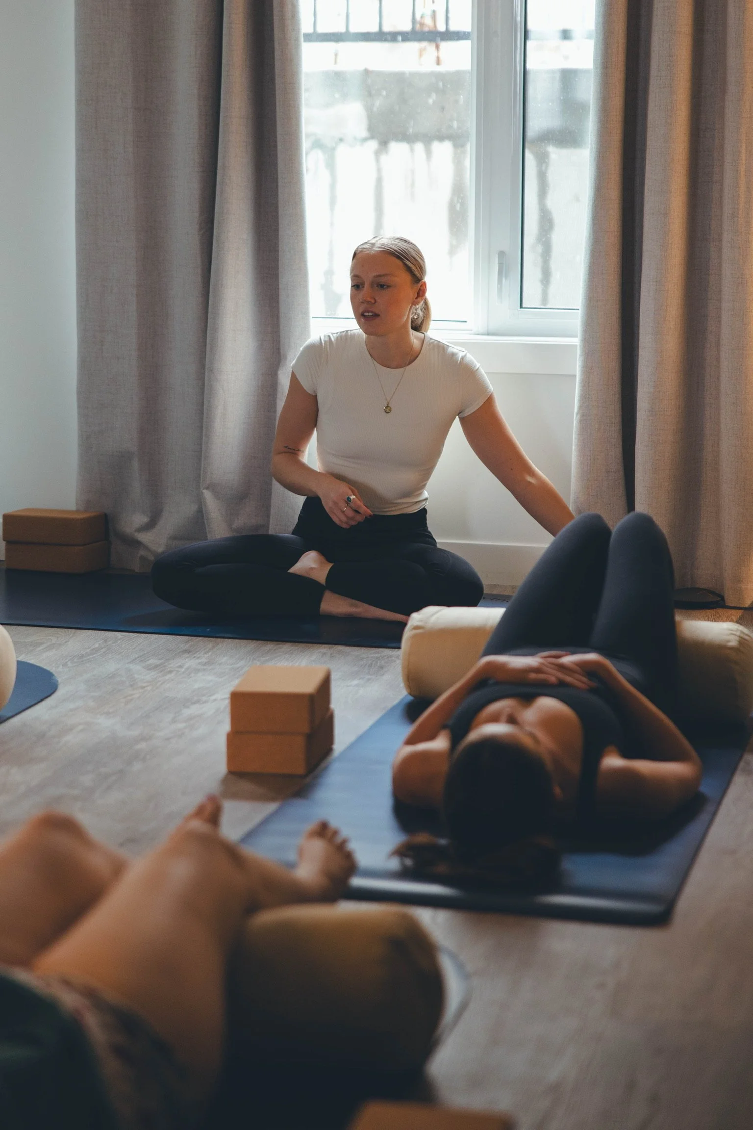 A woman leading a private yoga session in the guests private accomodation in Banff or Canmore
