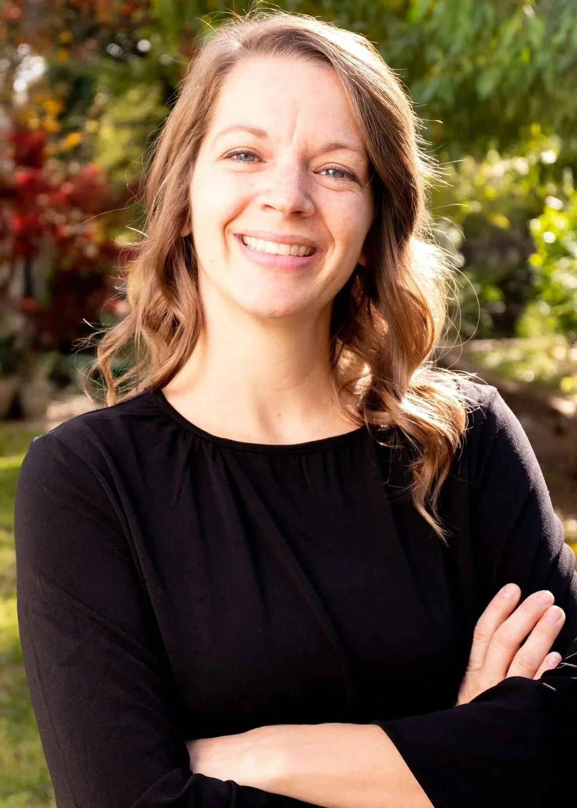 Andrea in a black shirt outdoors