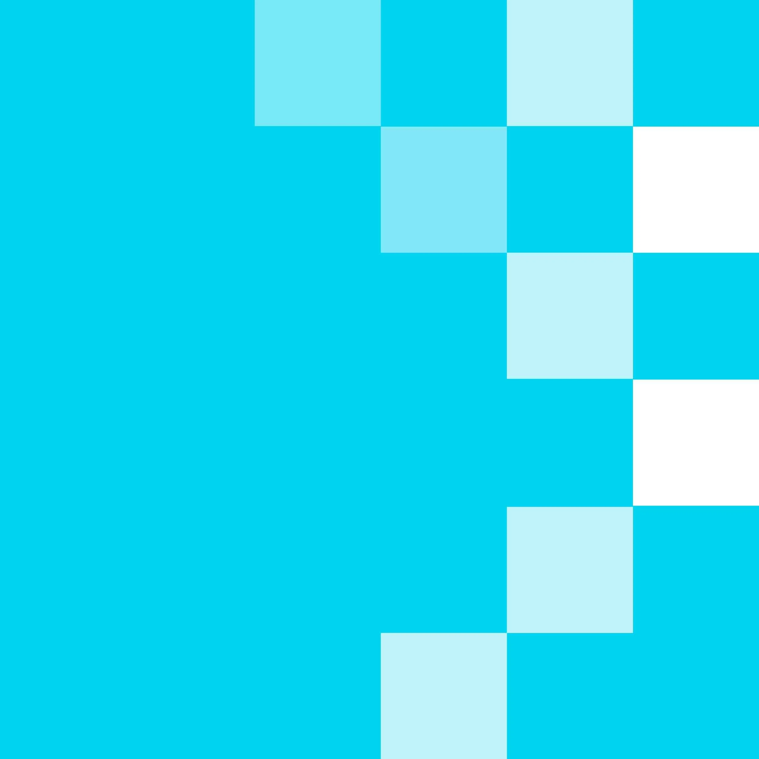 A young woman with long brown hair wearing a green shirt, smiling while lying on a bed and using a laptop.