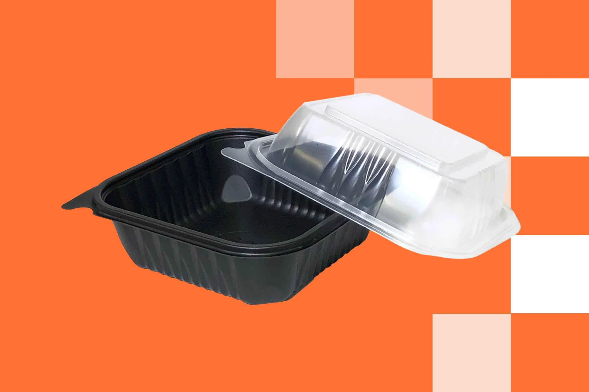 Black and white food takeout containers placed on an orange background.