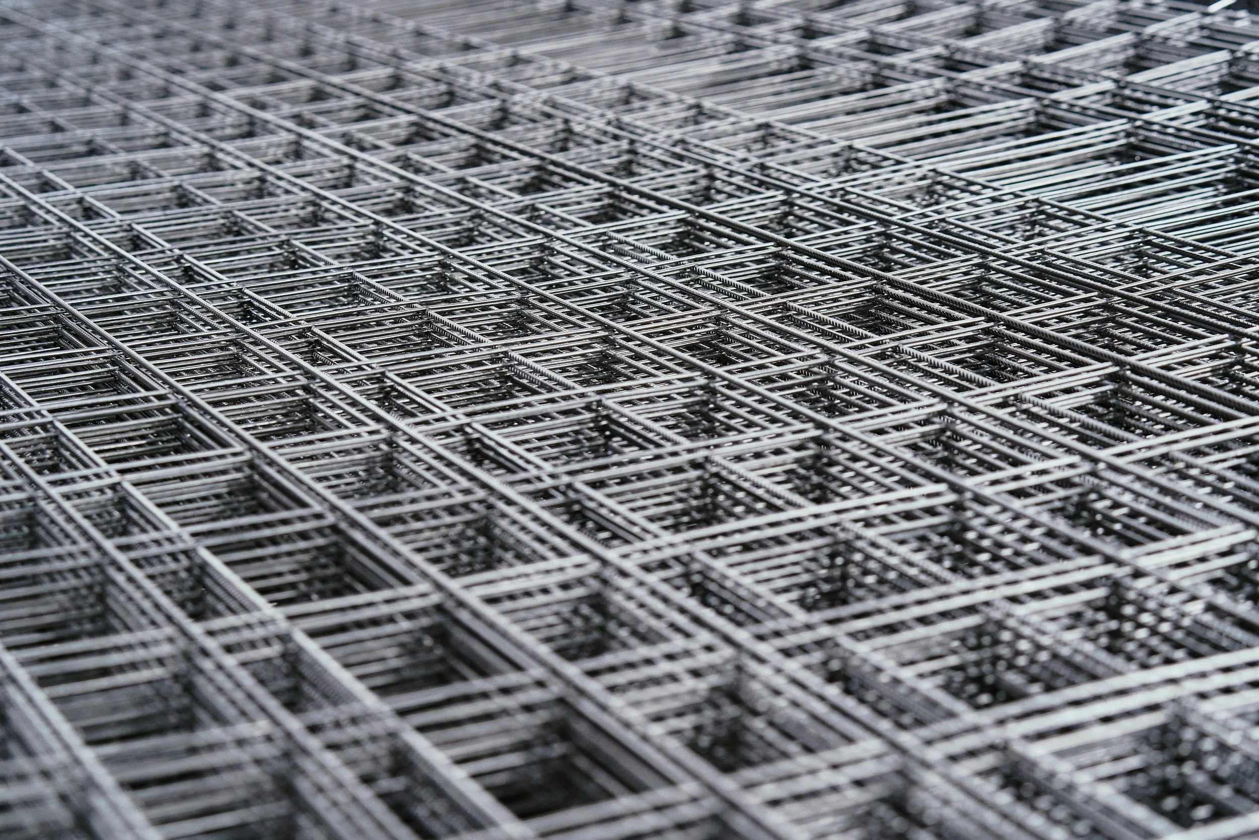 A large stack of metal shopping carts arranged in rows.
