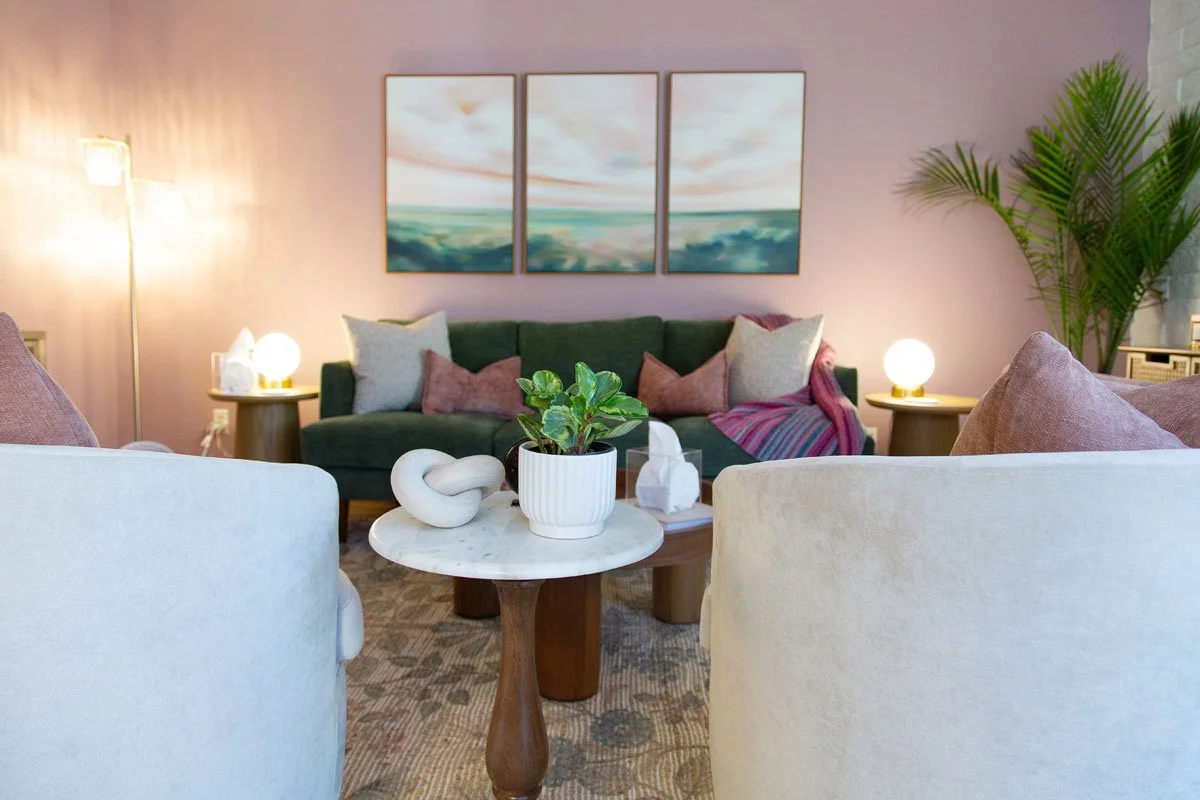 Rebecca's therapy office with sofa, comfy armchairs, and soft lighting.