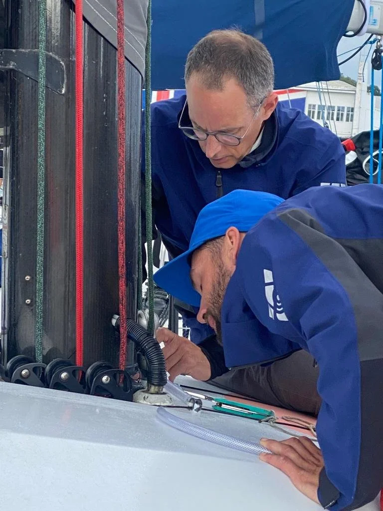 David Rowen inspecting Class 40 Cantaloop 40  mast and sail equipment, final preparations in Cowes before RORC Fastnet Race 2025.