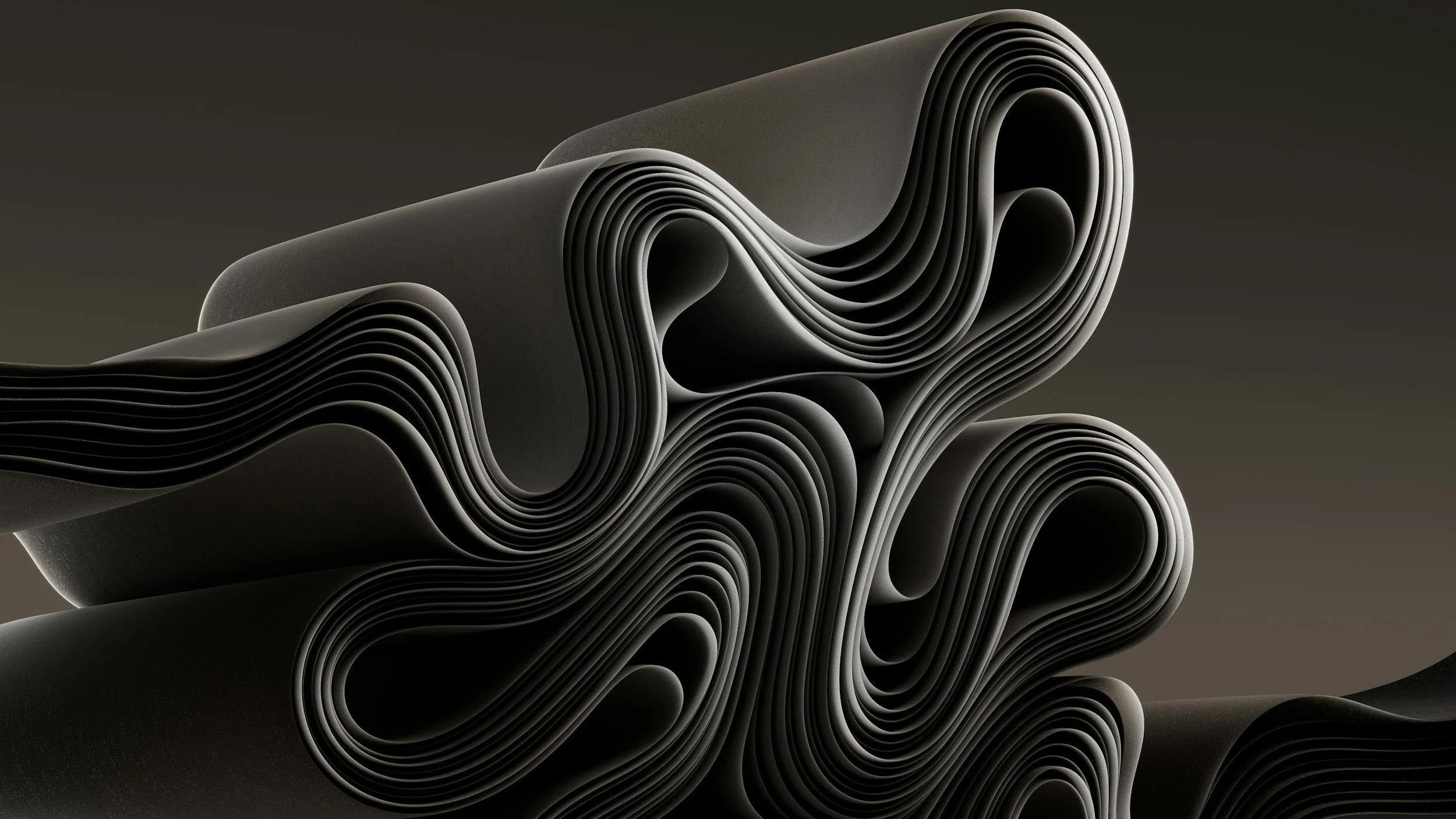 Abstract modern sculpture with wavy, layered black curves against a dark background.