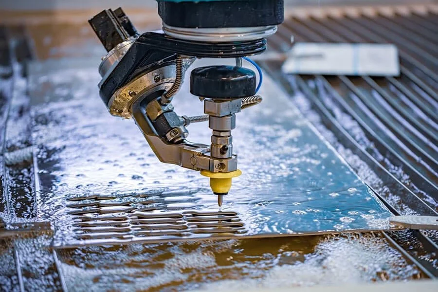 Industrial robot laser cutting sheet metal on a worktable.