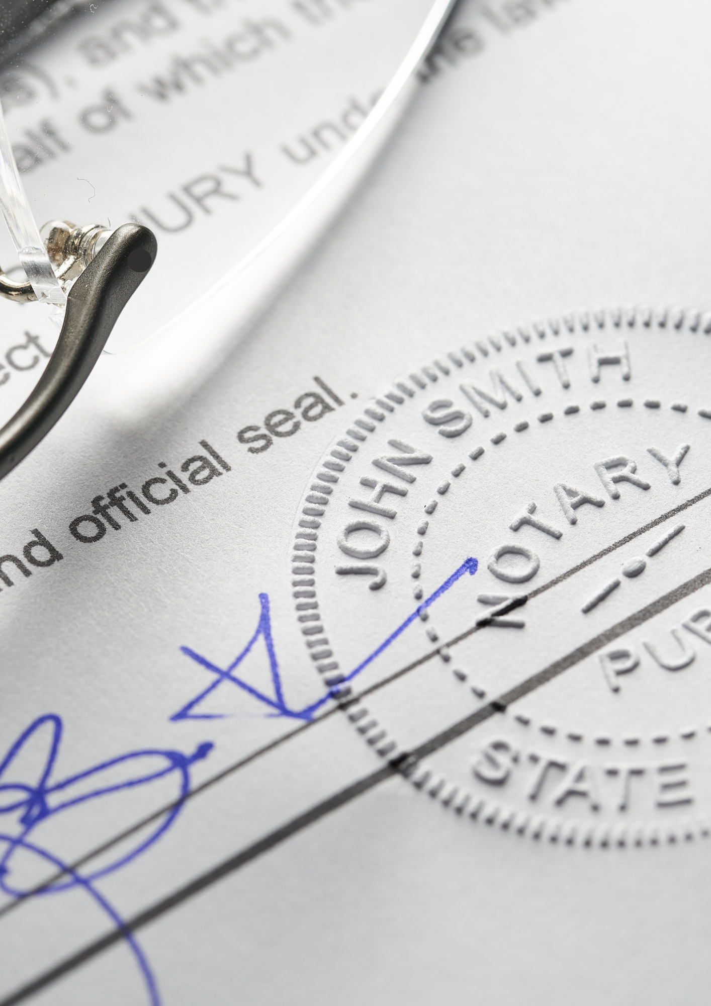 Close-up of a document with embossed official seal, with handwritten signatures and a blue checkmark, and a magnifying glass.