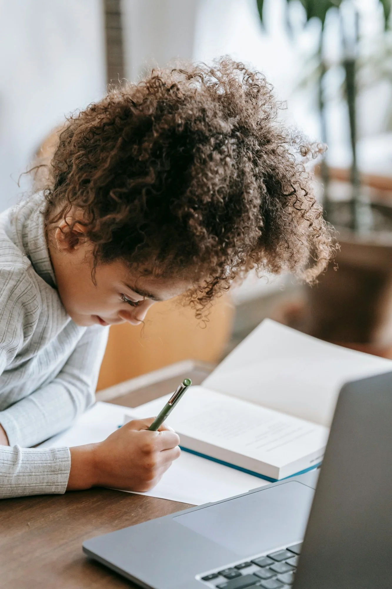 Child focused on writing practice during a homework session.