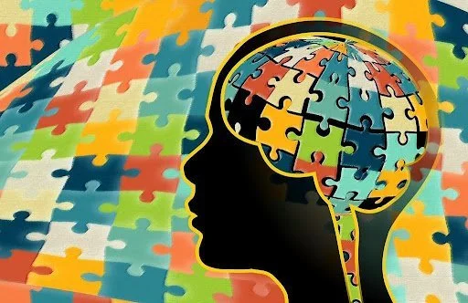 Puzzle-piece brain graphic representing autism learning support.
