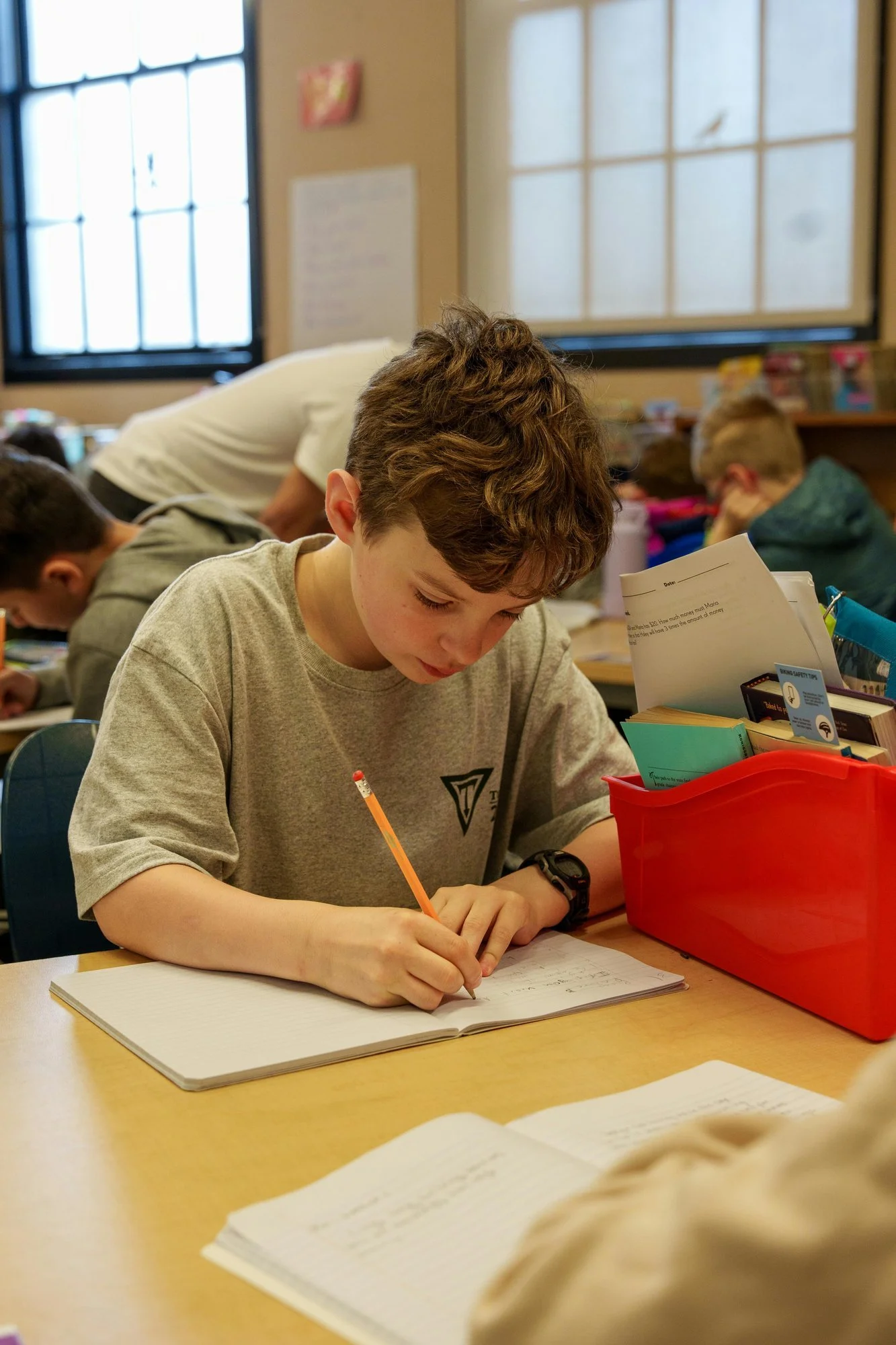Student writing during a classroom assignment.