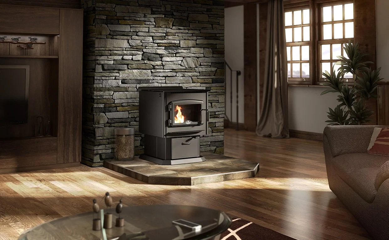 A cozy living room with a wood stove burning on a stone hearth, hardwood floors, a window with curtains, and a sofa with a patterned pillow.