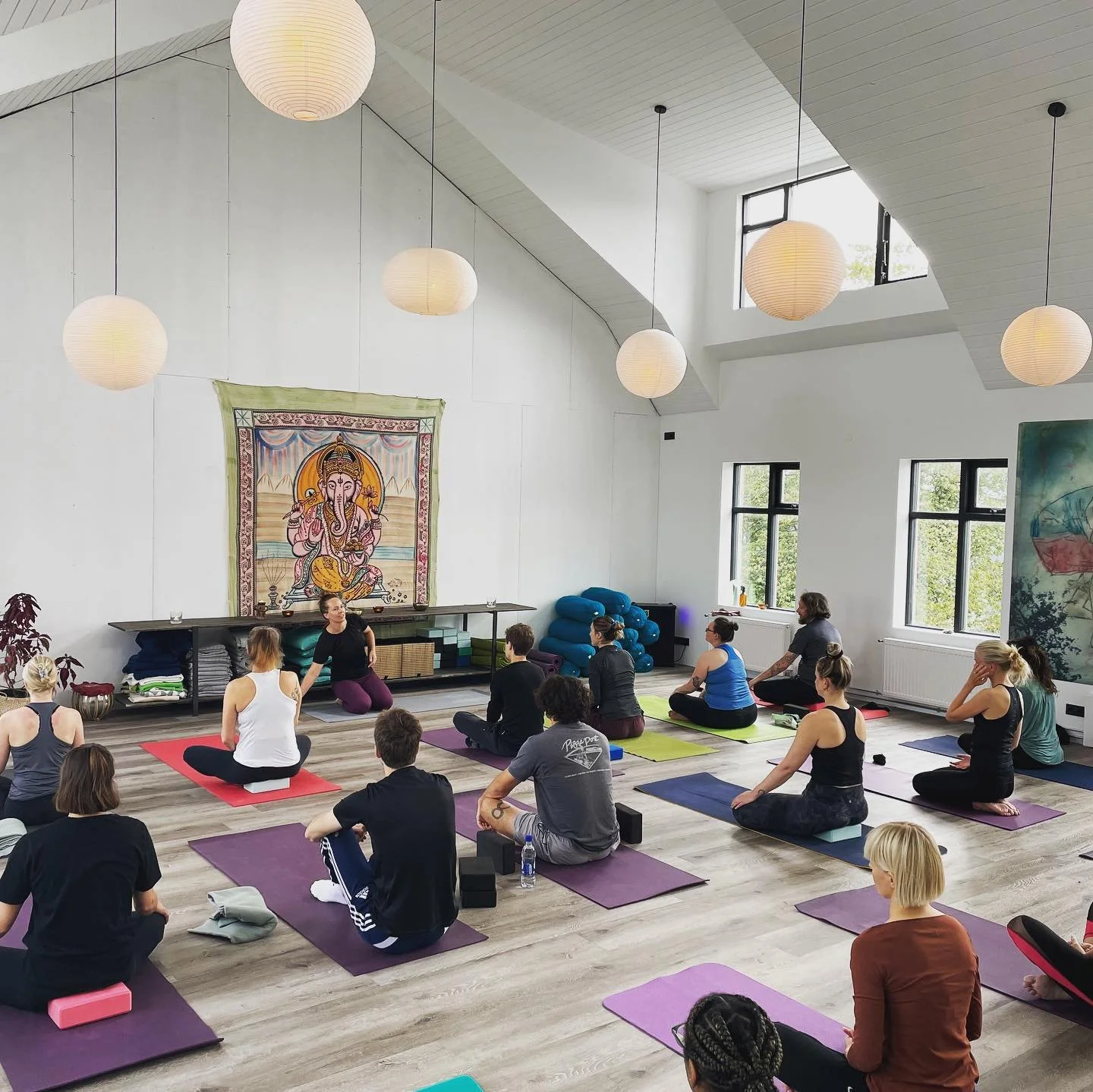 Group practising yoga together in a bright, airy studio in Dublin