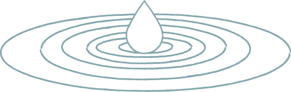 A single water droplet hitting a water surface, creating ripples.